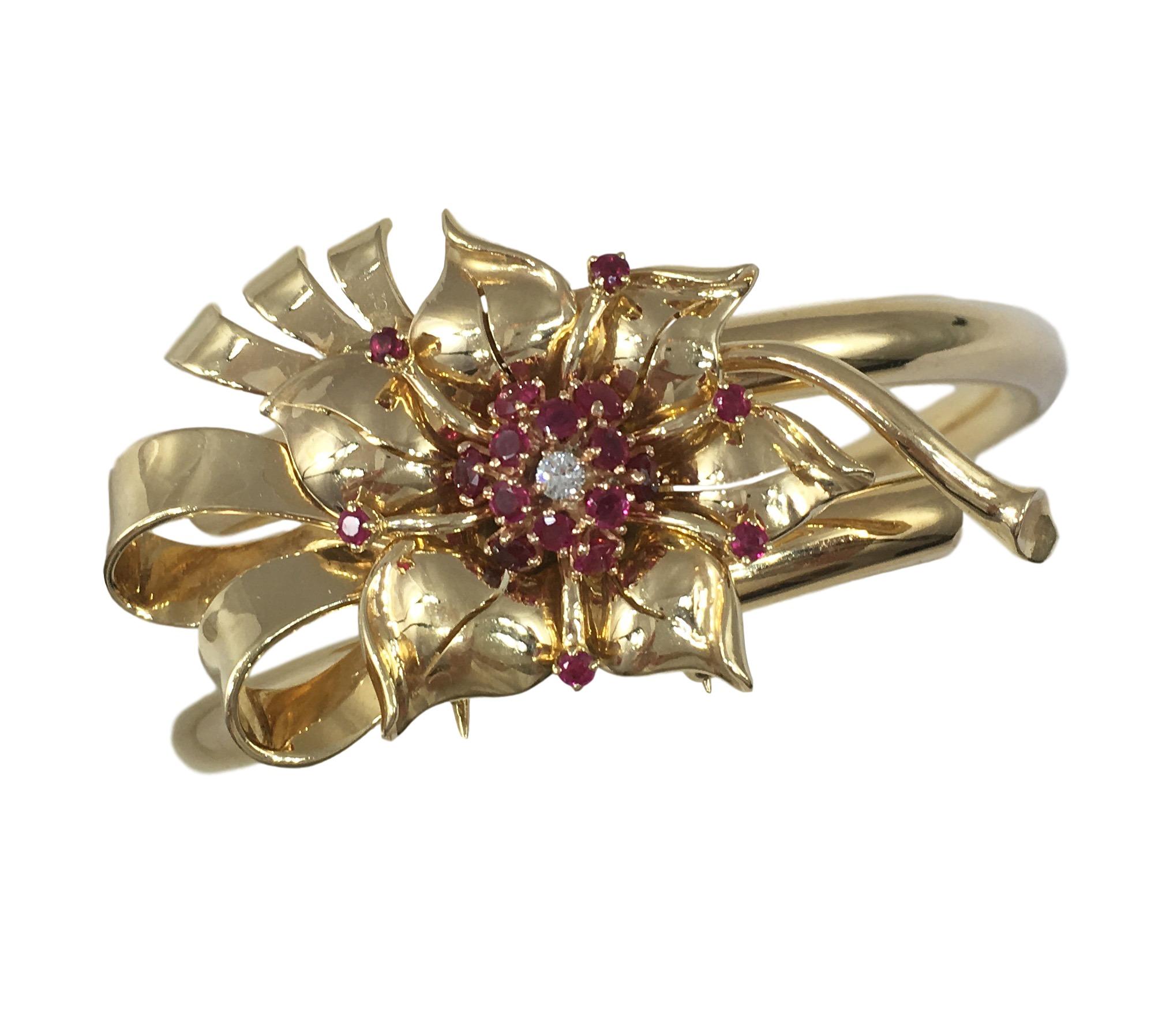 A fabulous bangle attributed to Paul Flato, created in the 1940’s.

This chic piece allows the flower head motif to be detached and worn independently as a brooch. The craftsmanship and design of this piece with its ingenious interlinking parts