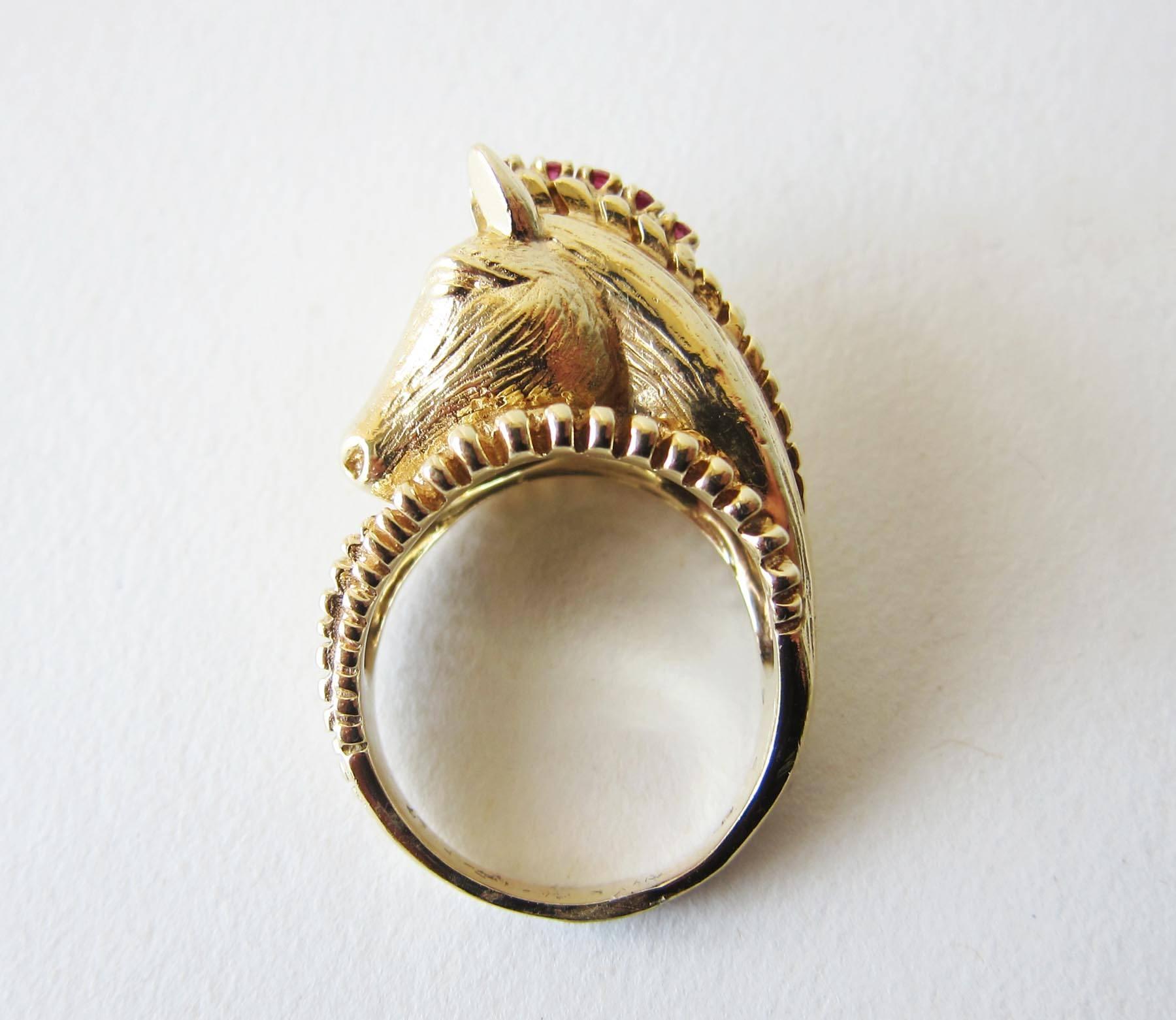 1970's 14k gold, ruby and diamond horse head ring, creator unknown.  One diamond in the forehead and 6 small rubies in the mane of the horse makes up this statement ring.  It is a finger size 8.5 and sits about 1/2