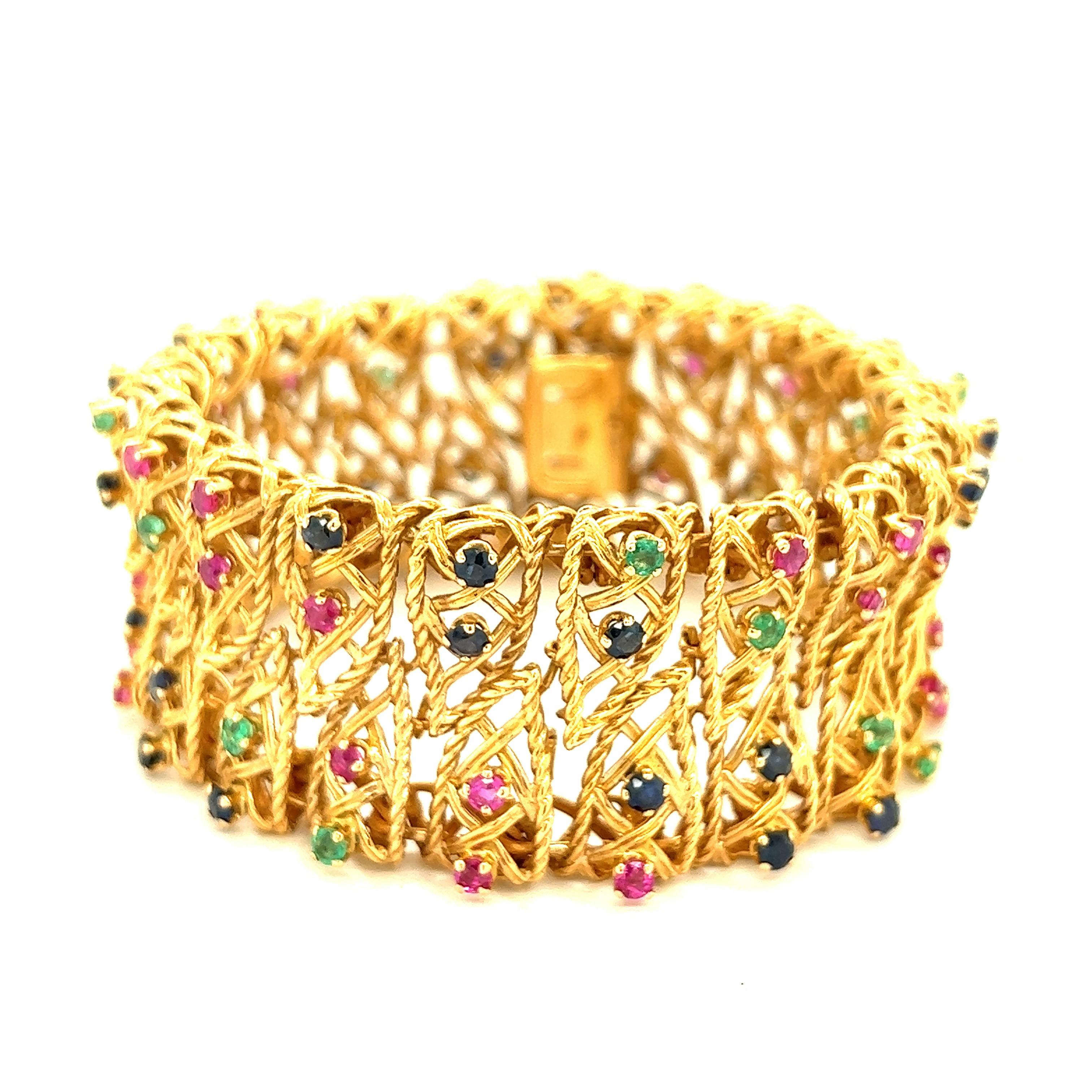 Ruby, Sapphire, & Emerald 18k Yellow Gold Bracelet 

Round-cut colored stones of 32 rubies (bright medium deep raspberry, cleanish to slightly included, several moderately included, lively); 32 sapphires (several brighter royal blue, mostly dark