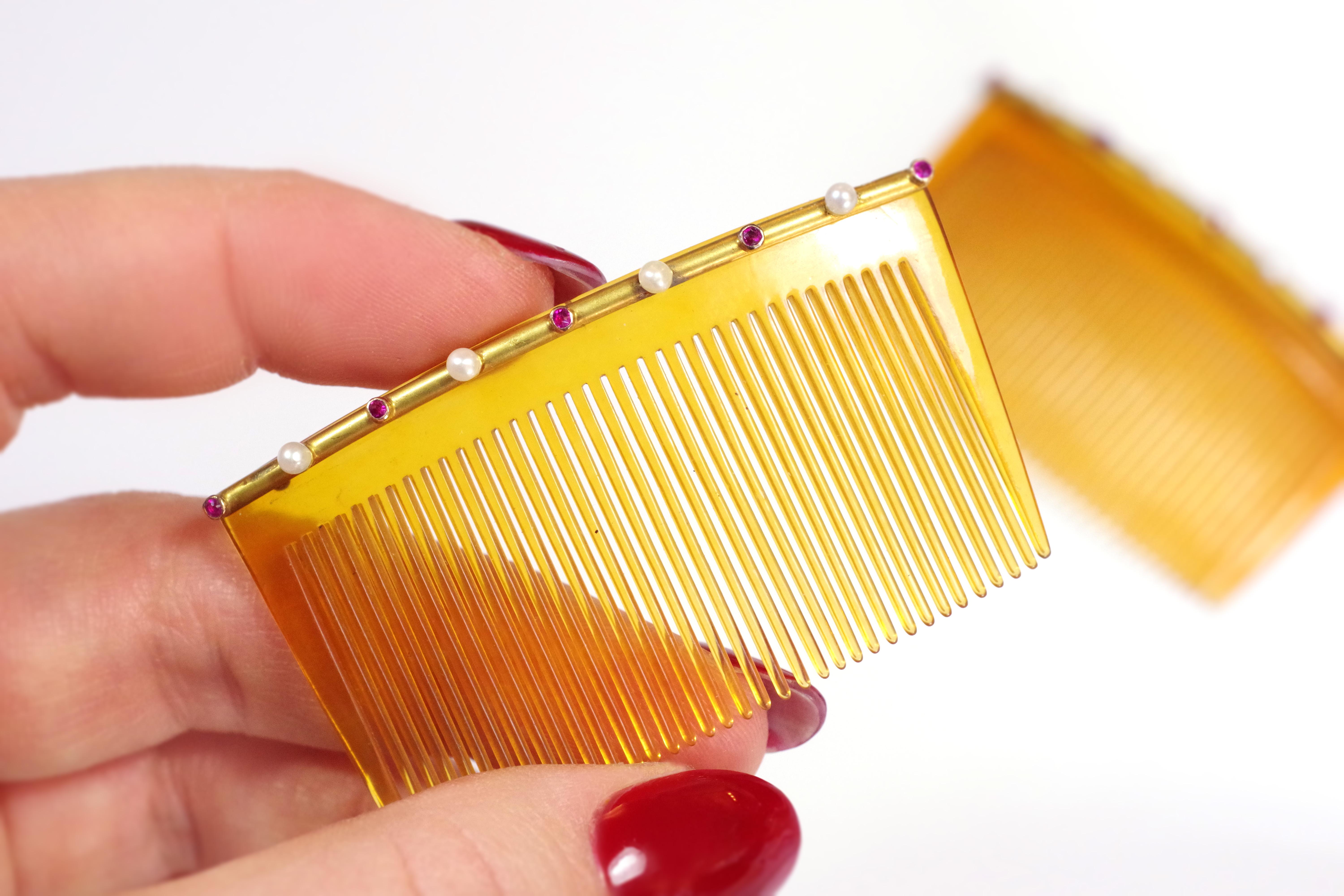 Gold ruby wedding combs in 14 karat yellow gold. Pair of hair combs decorated with a gold line applied on a structure of blond organic matter. The gold line is set with five round rubies, alternating with four fine pearls. One comb has 36 teeth.
