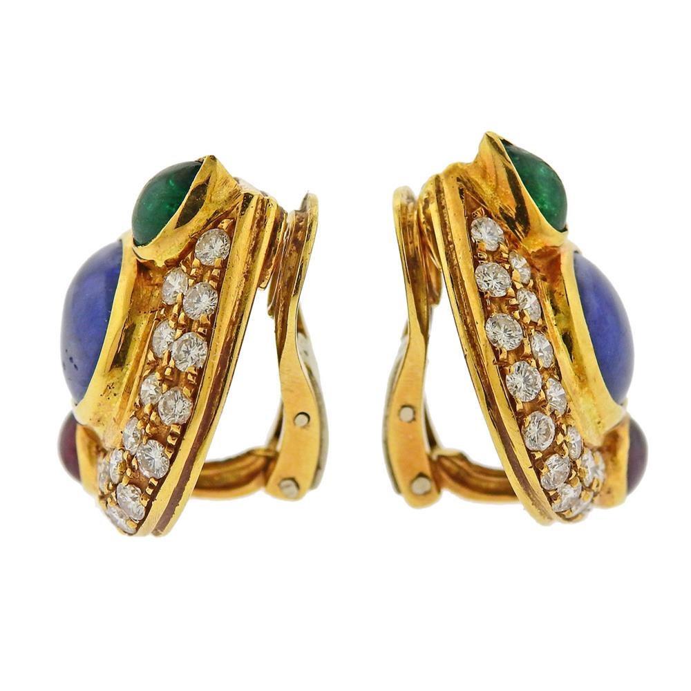 Pair of exquisite 18k yellow gold cocktail earrings, set with two sapphire cabochons (approx. 8.50ctw), 2.25ctw in diamonds, ruby and emerald (one is chipped)  cabochons. Earrings measure 23mm x 22mm. Tested 18k. Weigh 16.2 grams.