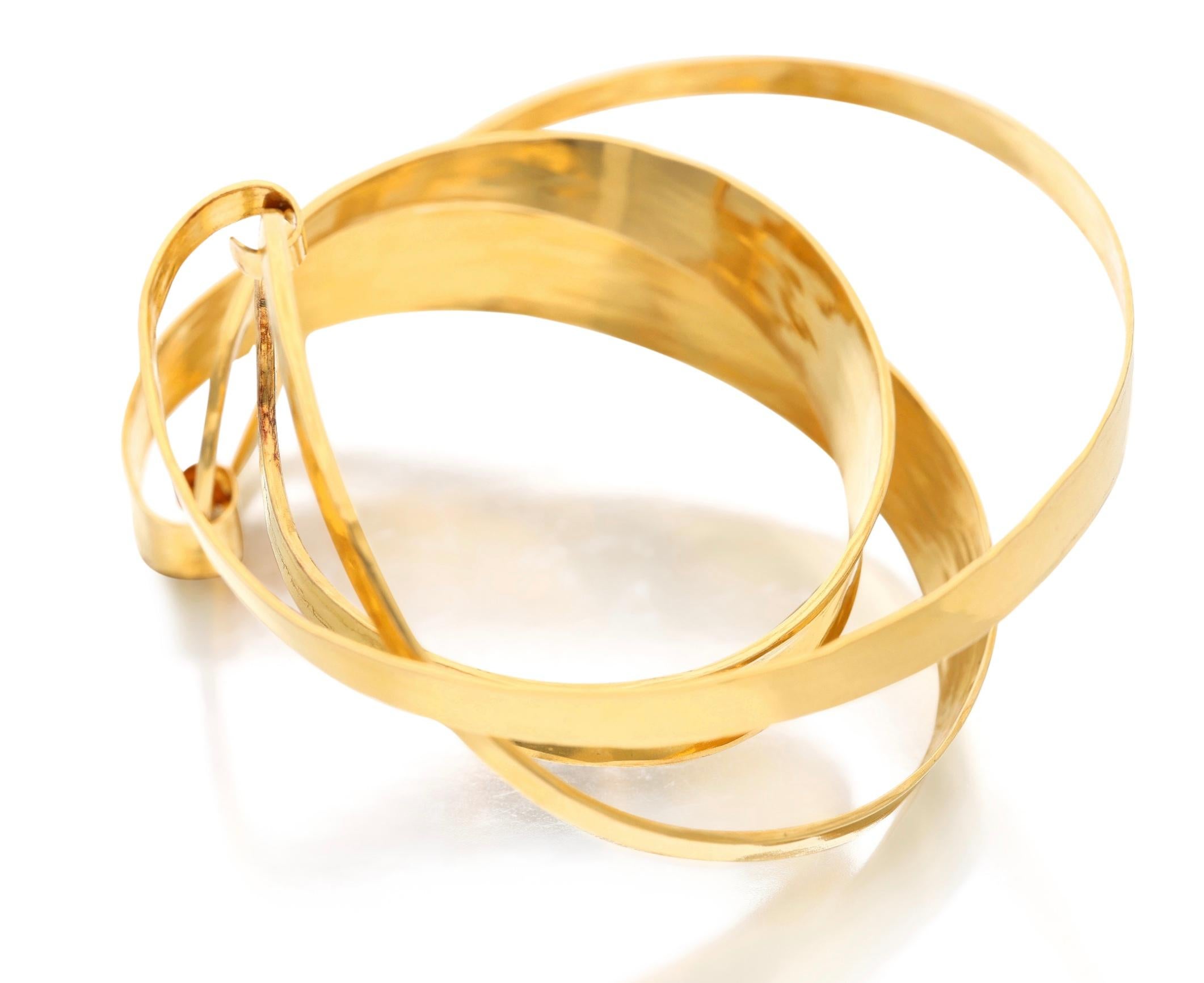 A gold sculptural cuff bracelet with a unique design. It is made out of 22 karat yellow gold with an inner circumference of 7 inches. Perfect for making a statement at an evening party. 