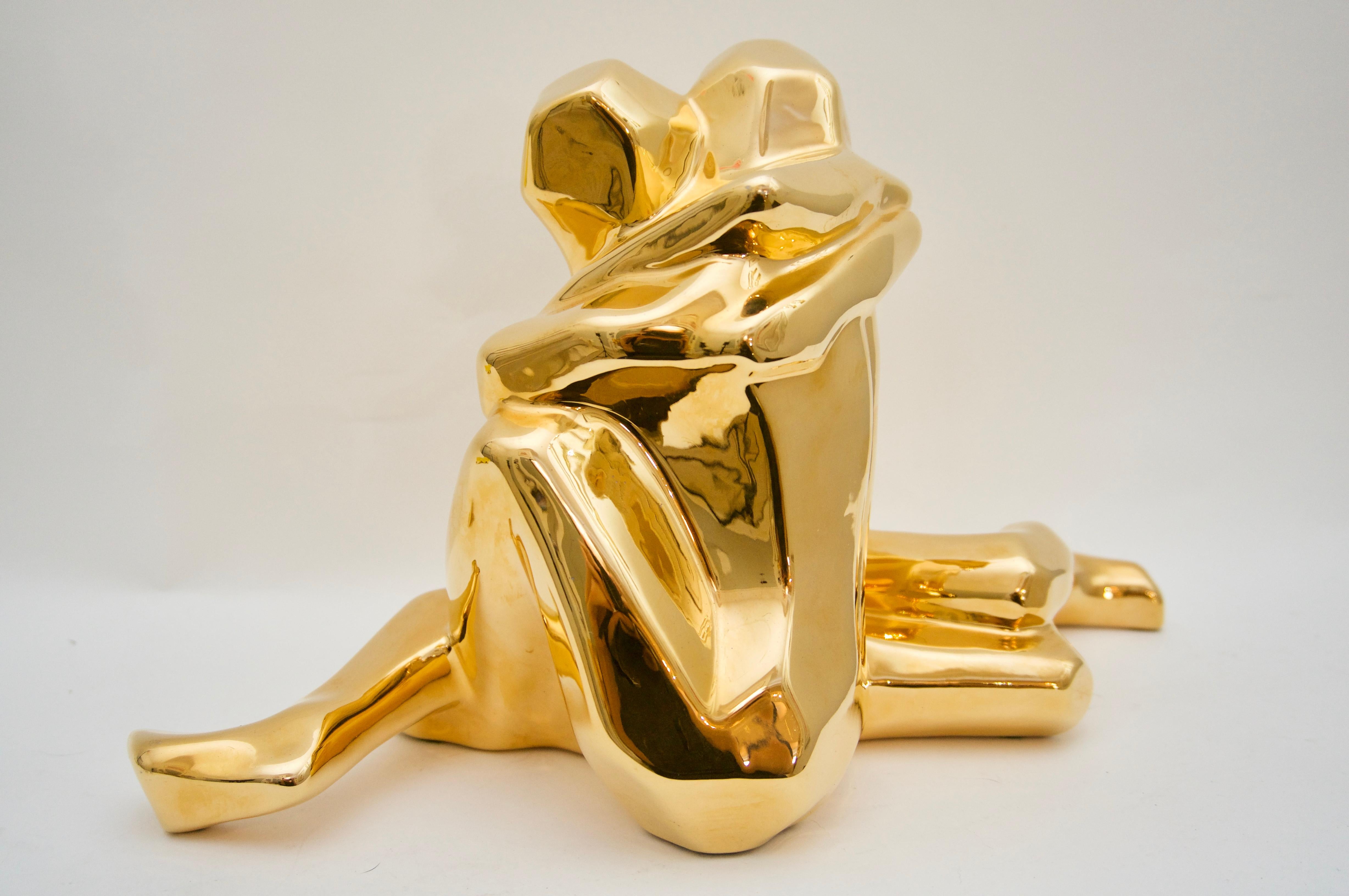 This stylish piece was created by Jaru of California and dates to the late 1970s and early 1980s. The figure is a couple embracing and is glazed in a high gloss gold.

Note: The dark spots you see in some images is a reflection.