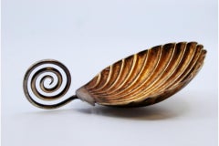 Gold serving spoon with curled handle