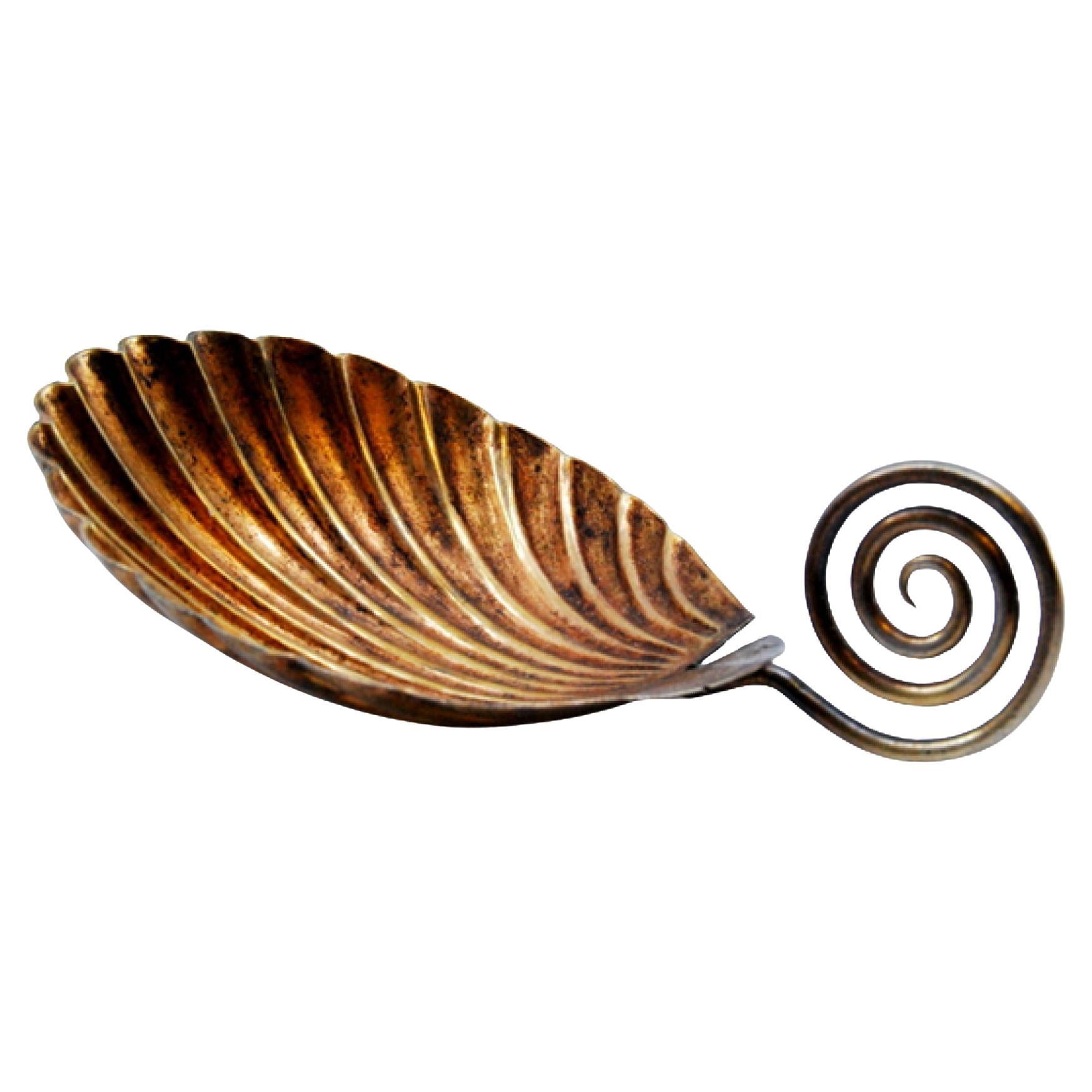 Gold serving spoon with curled handle