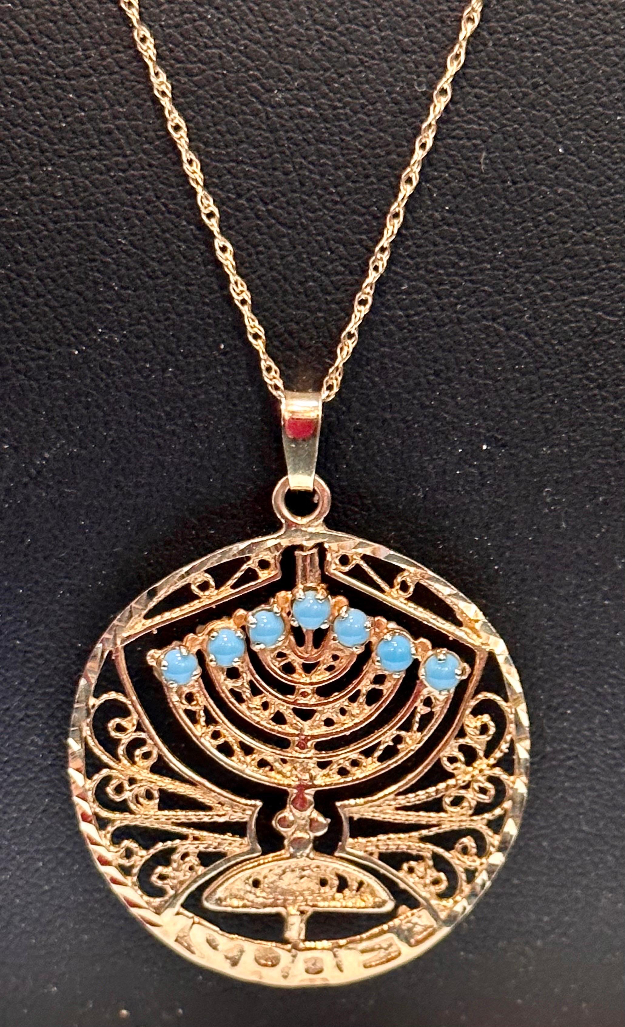 
Gold Shabbat Menorah Ruby and Turquoise Pendant Necklace with chain.
This is a Menorah which has ruby on one side and turquoise on the other side.
Good gift for Jewish people during Hanukkah.
Looking for a stunning piece of jewelry to add to your