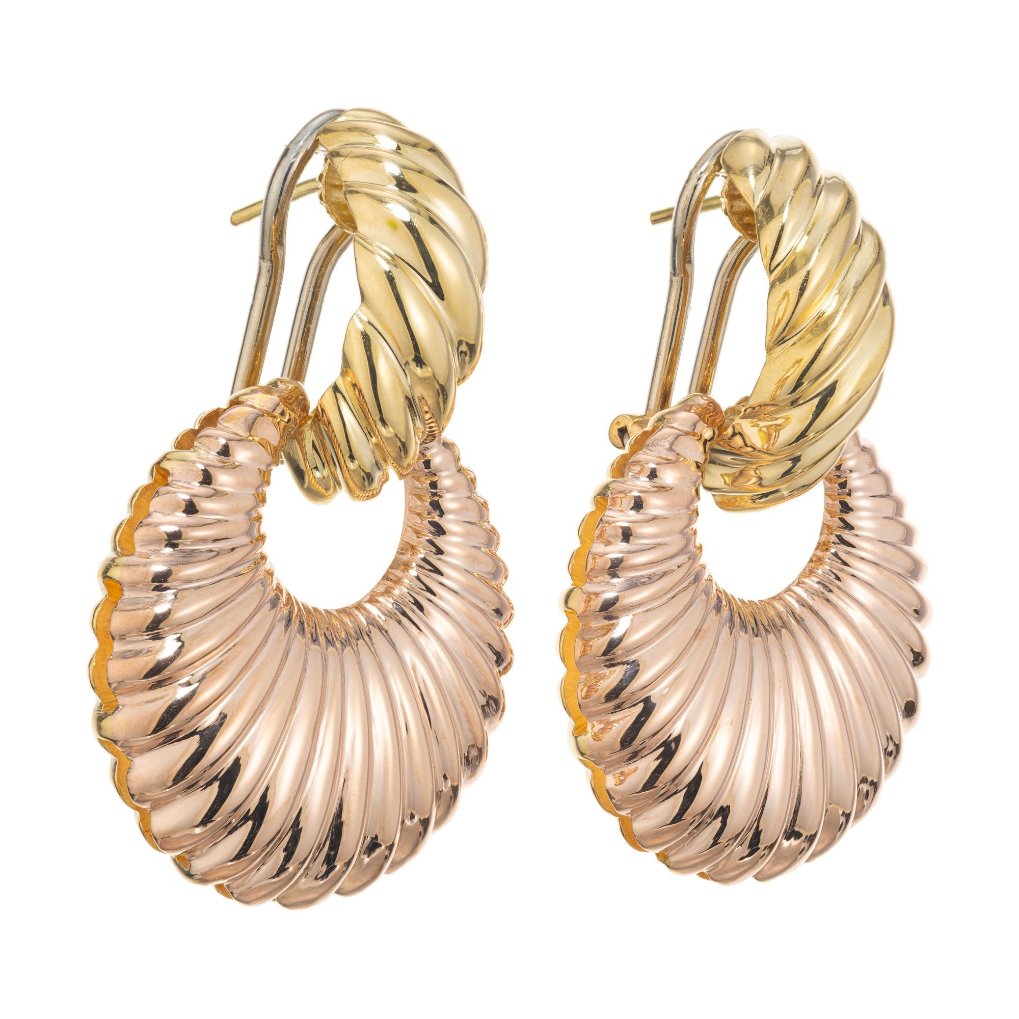 Two tone 18k rose and yellow gold dangle earrings. Shrimp style yellow gold tops with 18k white gold clip post earrings with each sporting a detachable round graduated 18k rose gold ribbed fan style dangle. Rich rose gold color complimented by