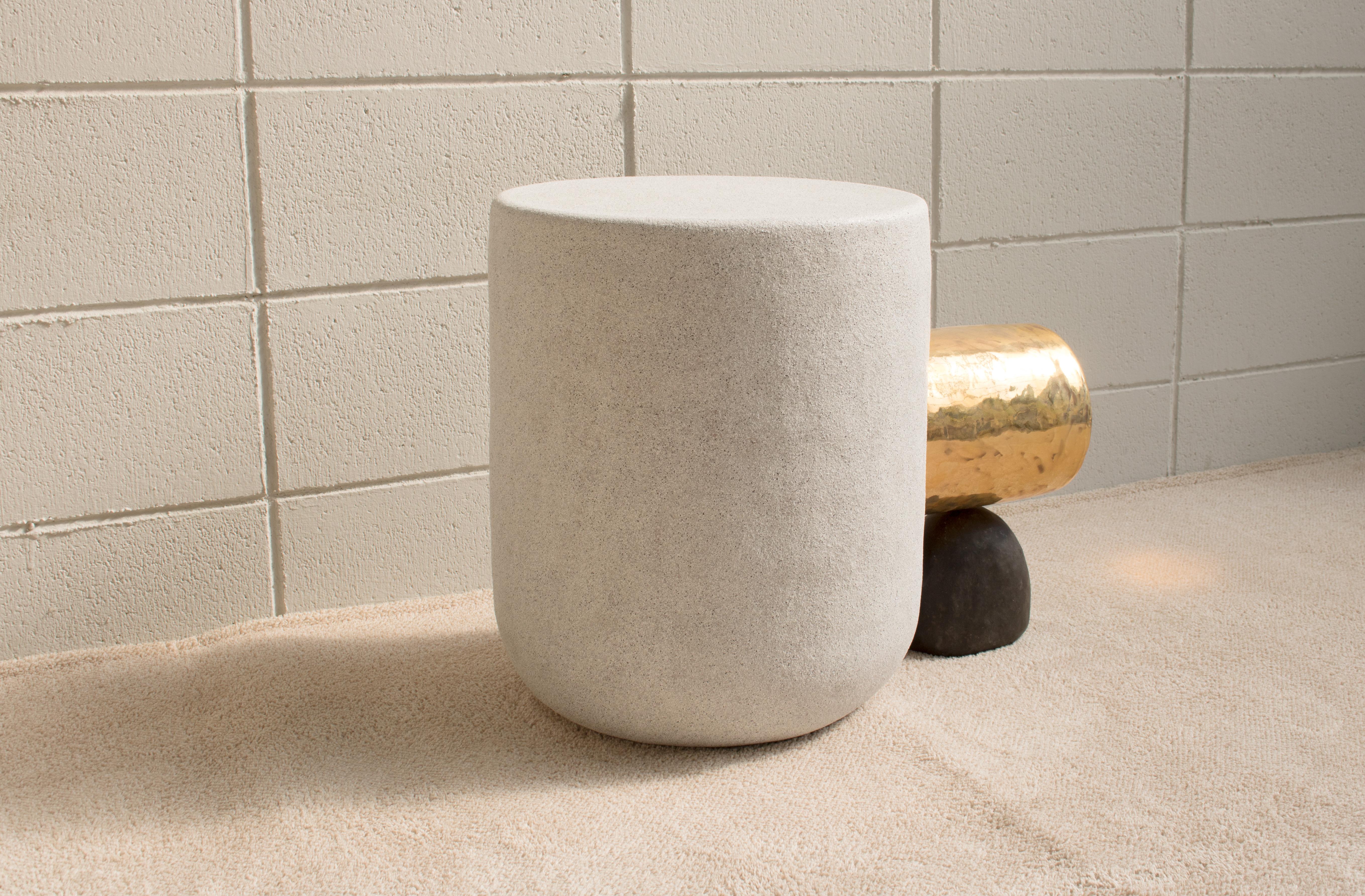A side table with cylindrical shape. The existing ceramic process was manufactured with clay, the process of making contains the process of biscuit [bisque] firing, the process of glazing, and the process of firing. But this piece was slightly