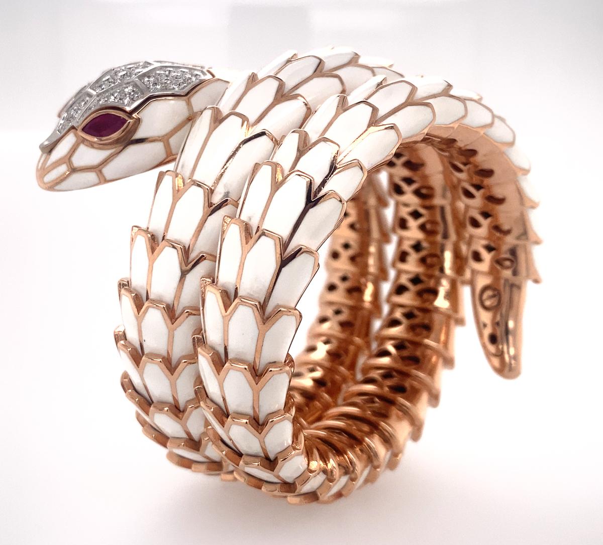 Very beautiful snake, the scales applied with white enamel, the eyes set with marquise-shaped rubies, further enhanced with pavé-set round brilliant-cut diamonds approx. 1.10 cts and 0.55 cts of rubies.  Head is a watch and currently working in