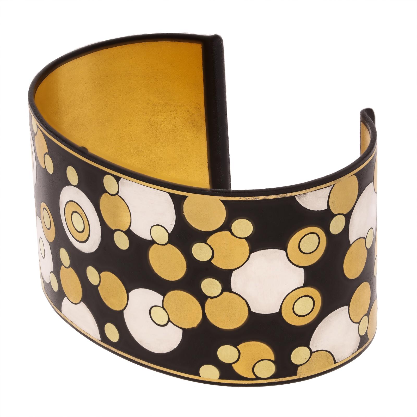 A stylish gold, silver and iron ‘Bubbles’ cuff designed by Angela Cummings for Tiffany & Co. c.1980, the wide straight cuff bangle made using the Damascene technique of inlaying mixed metals into a darkly oxidised background to create a dramatic