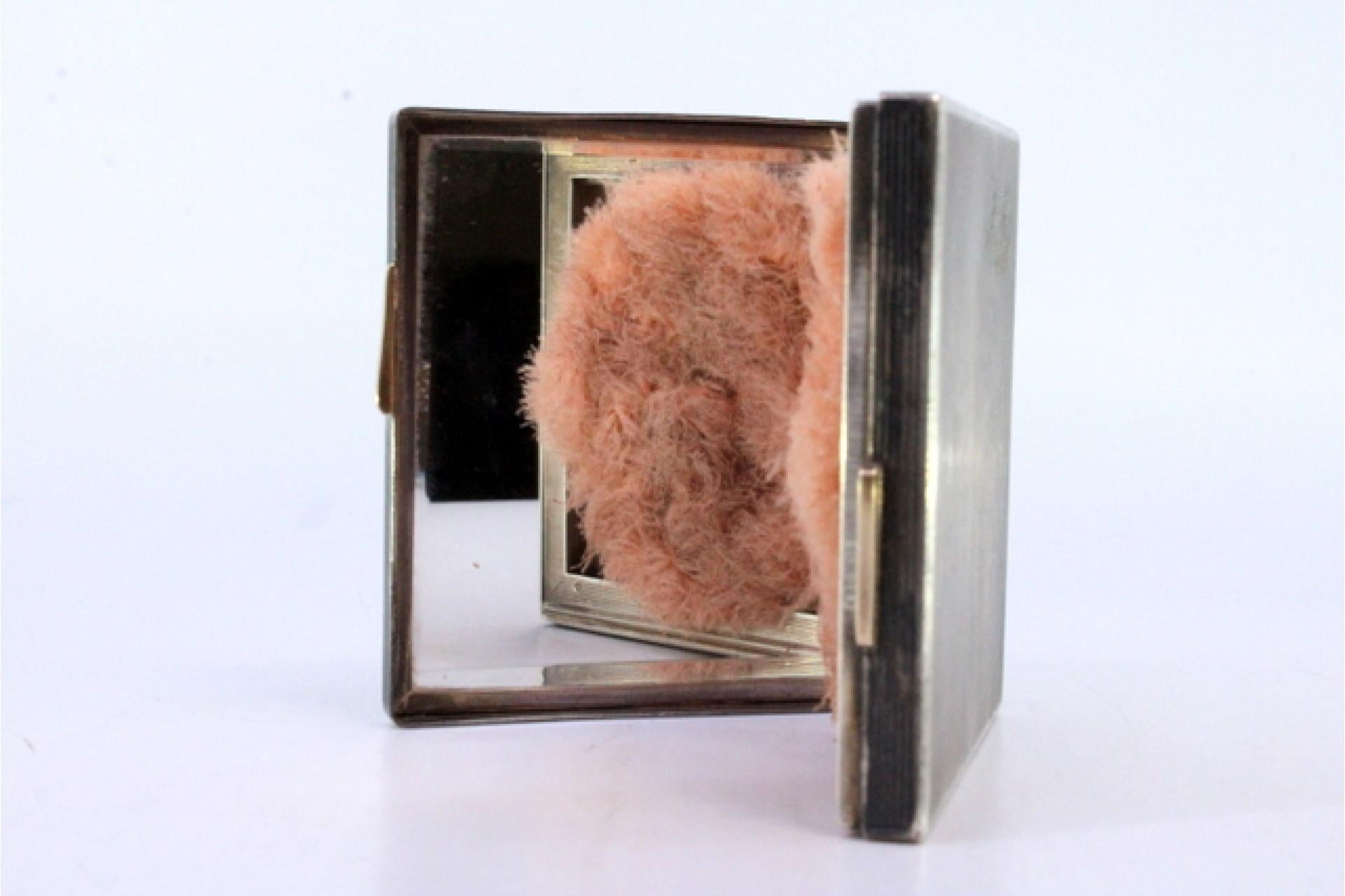 Description: Gold and silver toiletry box with beaded decoration, embossed dog on the lid and interior with mirror and powder pom-pom. Metal: Gold - Silver. Origin: European. Brand: Unknown. Weight: 152.97 grams. Dimensions: 7.5cmx7.5cm. Content: