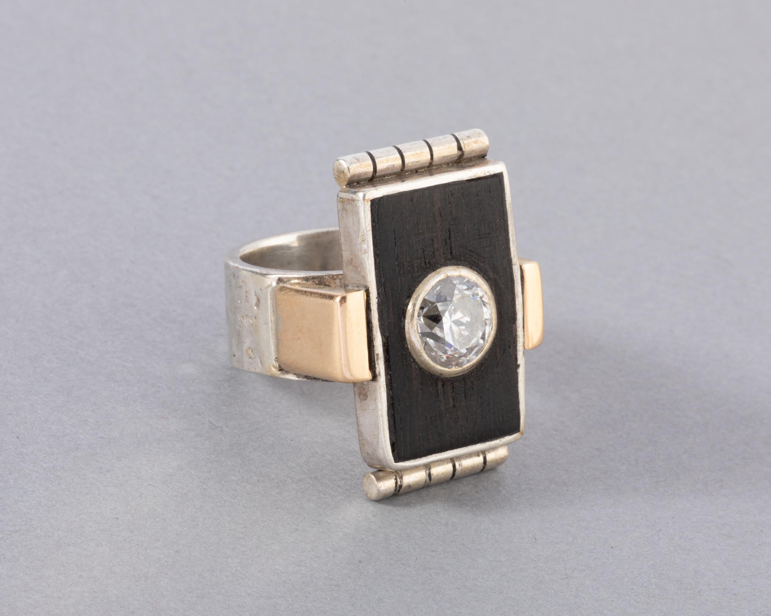 One rare and beautiful ring made by great French Creator Jean Desprès.
Made in France circa 1930.
Made in silver, gold 18k, ebony wood and set with a 1.80 carats diamond. The diamond is L SI2 approximately.
Dimension: 28*20 mm for the front. 27 mm