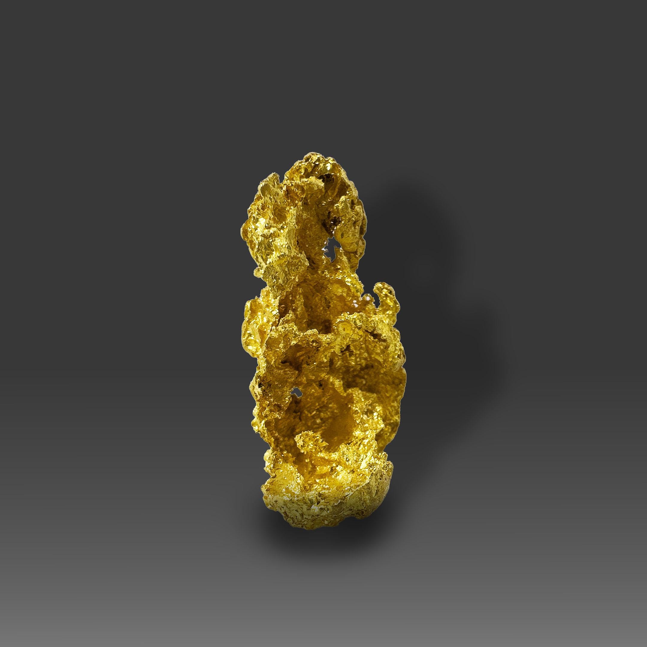 This remarkable Gold single crystal specimen from California showcases an exceptionally rare and elegant natural formation. Rising 32mm in height, this crystalline gold displays intricate sculptural contours and an open, lattice-like structure that