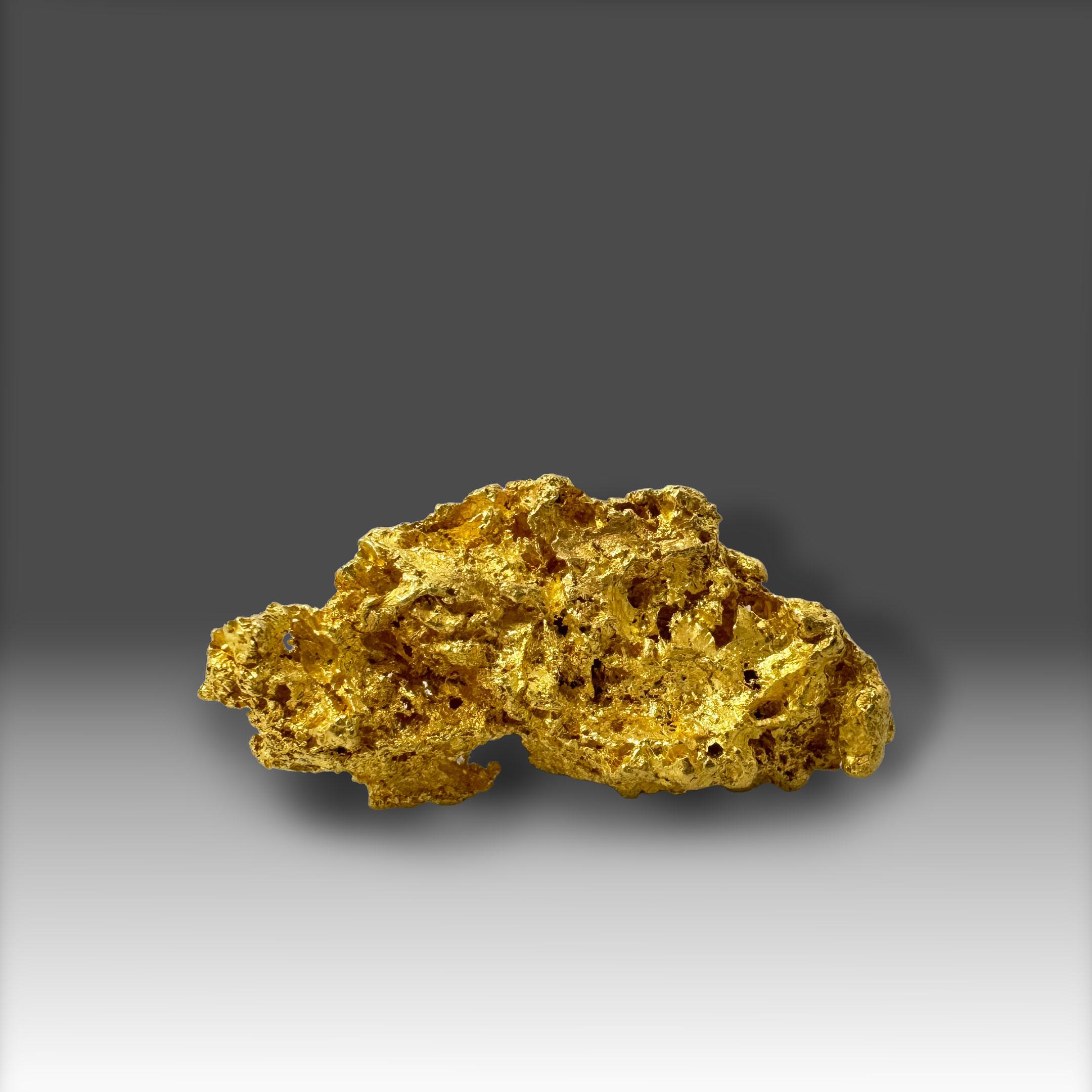 This superb and substantial California Gold crystal exemplifies the distinctive beauty of naturally crystallized native gold. The specimen displays a dense and sculptural form with vivid, mirror-bright luster across an intricate surface. Its complex