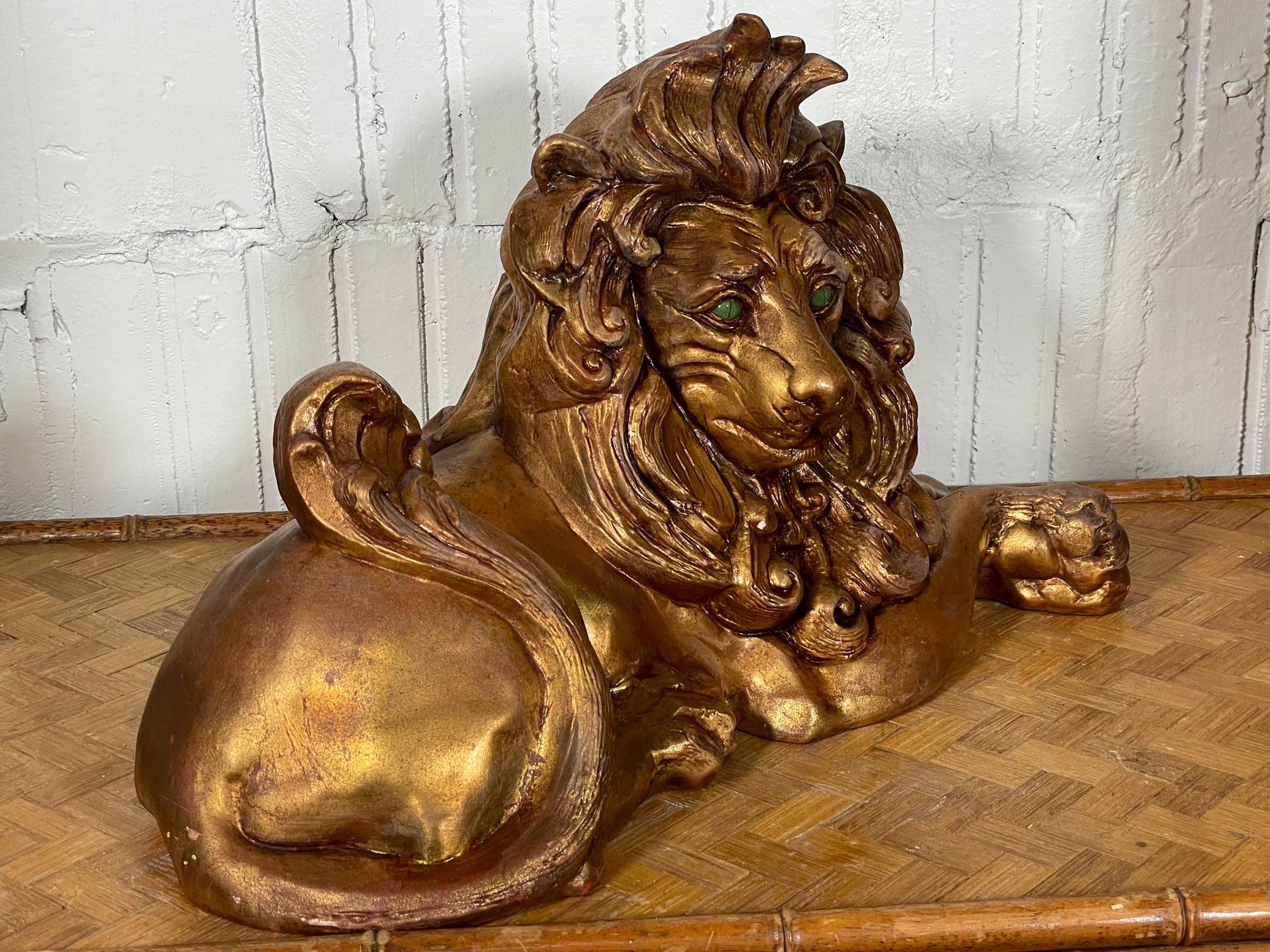 Early 1970s lion statue by California Pottery features jade eyes and a gold finish. Very good condition with only very minor imperfections consistent with age.