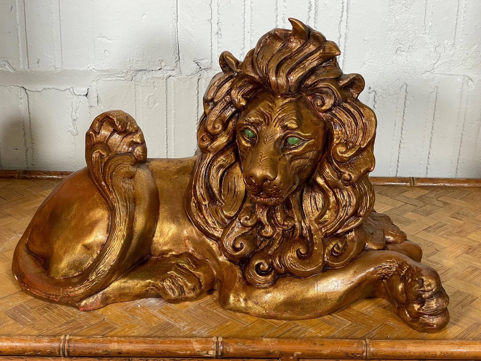 Early 1970s lion statue by California Pottery features jade eyes and a gold finish. Very good condition with only very minor imperfections consistent with age.
 