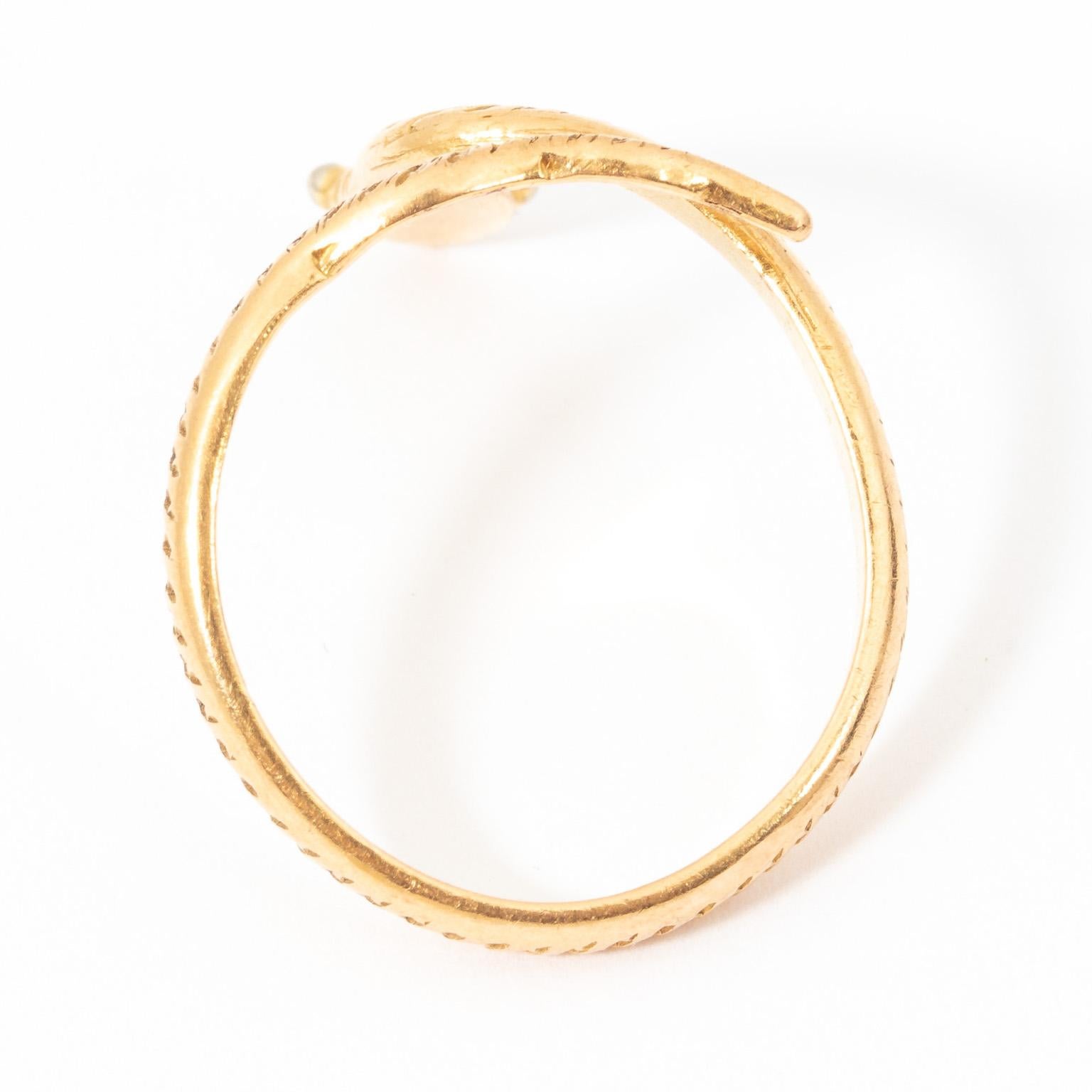 Circa mid-20th century snake ring in 18 Karat Gold. Handmade and can be sized either larger or smaller if necessary. Eyes are detailed with White Gold. Size 7.50. Weight 4.40 Grams.