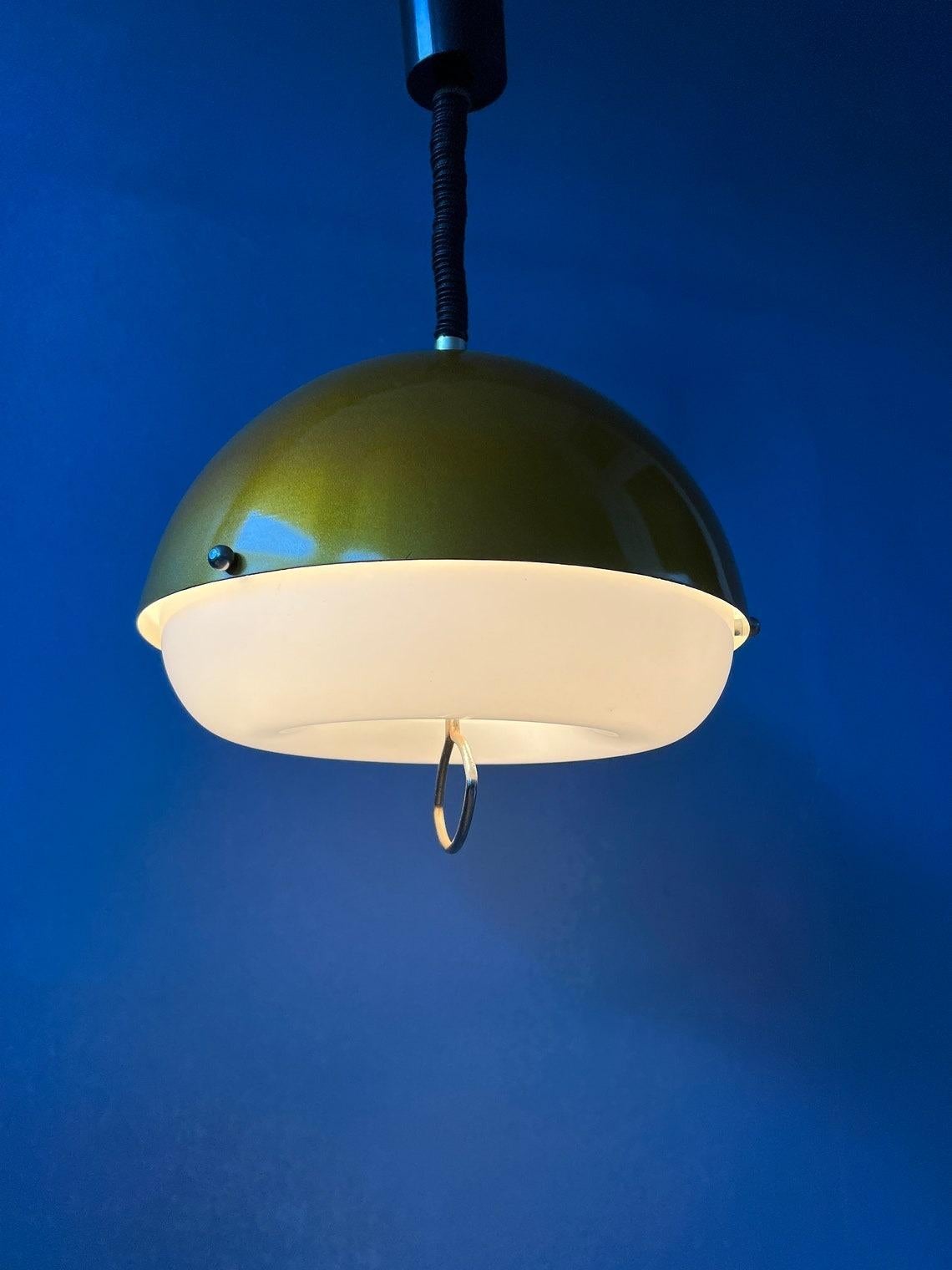 Very rare space age pendant lamp with metallic, golden upper shade and acrylic lower shade. Experience the golden glow cast by the pendant light as it bathes your space in a soft, luminous ambiance. The light dances off the metallic surface,