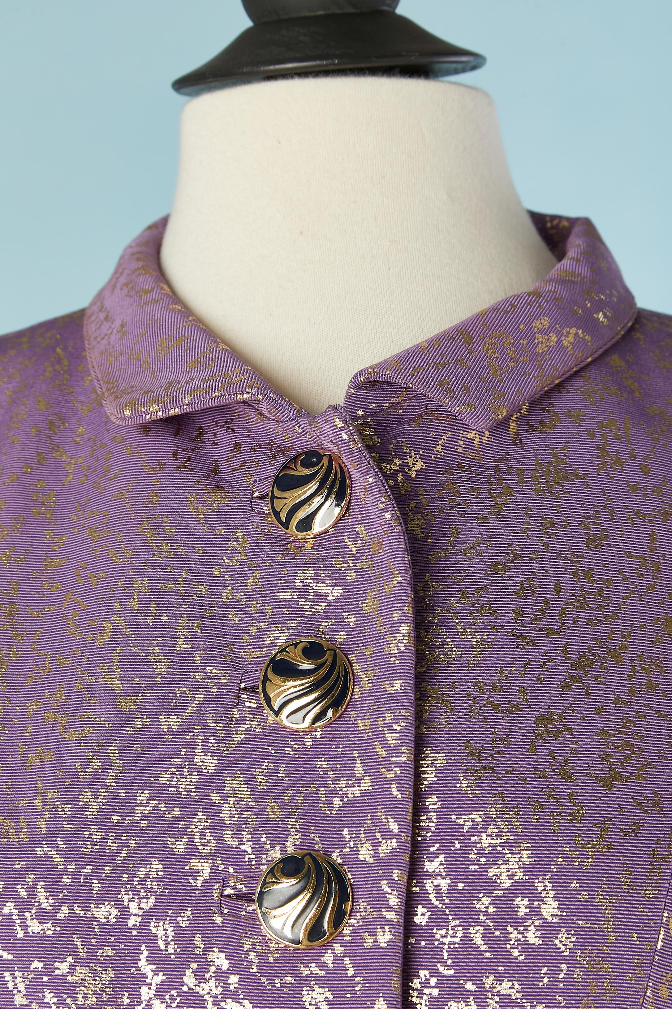 Gold speckled purple fabric jacket with jewelery buttons. Main fabric composition: 65% cotton, 35% rayon. Silk lining. 
Button and buttonhole in the middle front and middle back. Same for the pockets. 
One extra button provided. Shoulder-pad. 
SIZE