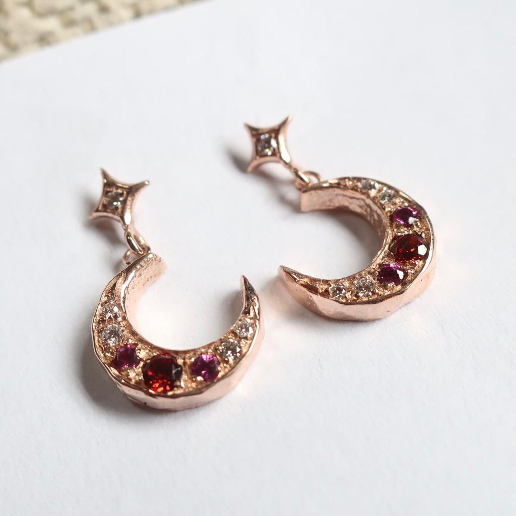 Romantic Art Nouveau inspired crescent moon earring set with red and pink garnets and diamond pave. These post earrings are delicate with the moon diameter about 11mm.  A red 3mm garnet is bead set with two 2.25mm rhodolite garnets and white vs