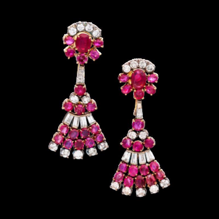 Each featuring an oval-shaped ruby, accented by round rubies and round brilliant diamonds, with a skirt of round rubies and tapered baguette diamonds.
 - Diamonds weighing a total of approximately 2.66 carats 
- Rubies weighing a total of