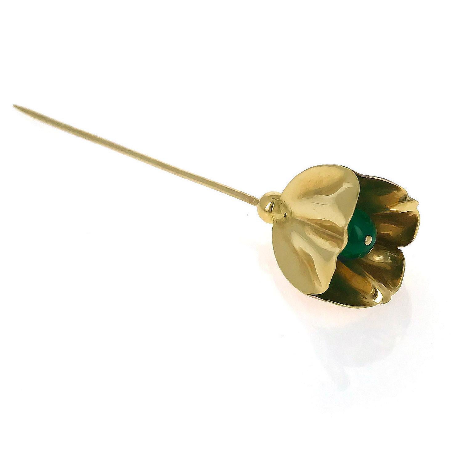 This Cartier stick pin brooch was created circa 1950. It is designed as a tulip and centers upon a chalcedony bead. It is mounted in 14 karat yellow gold. This brooch is signed and numbered. 