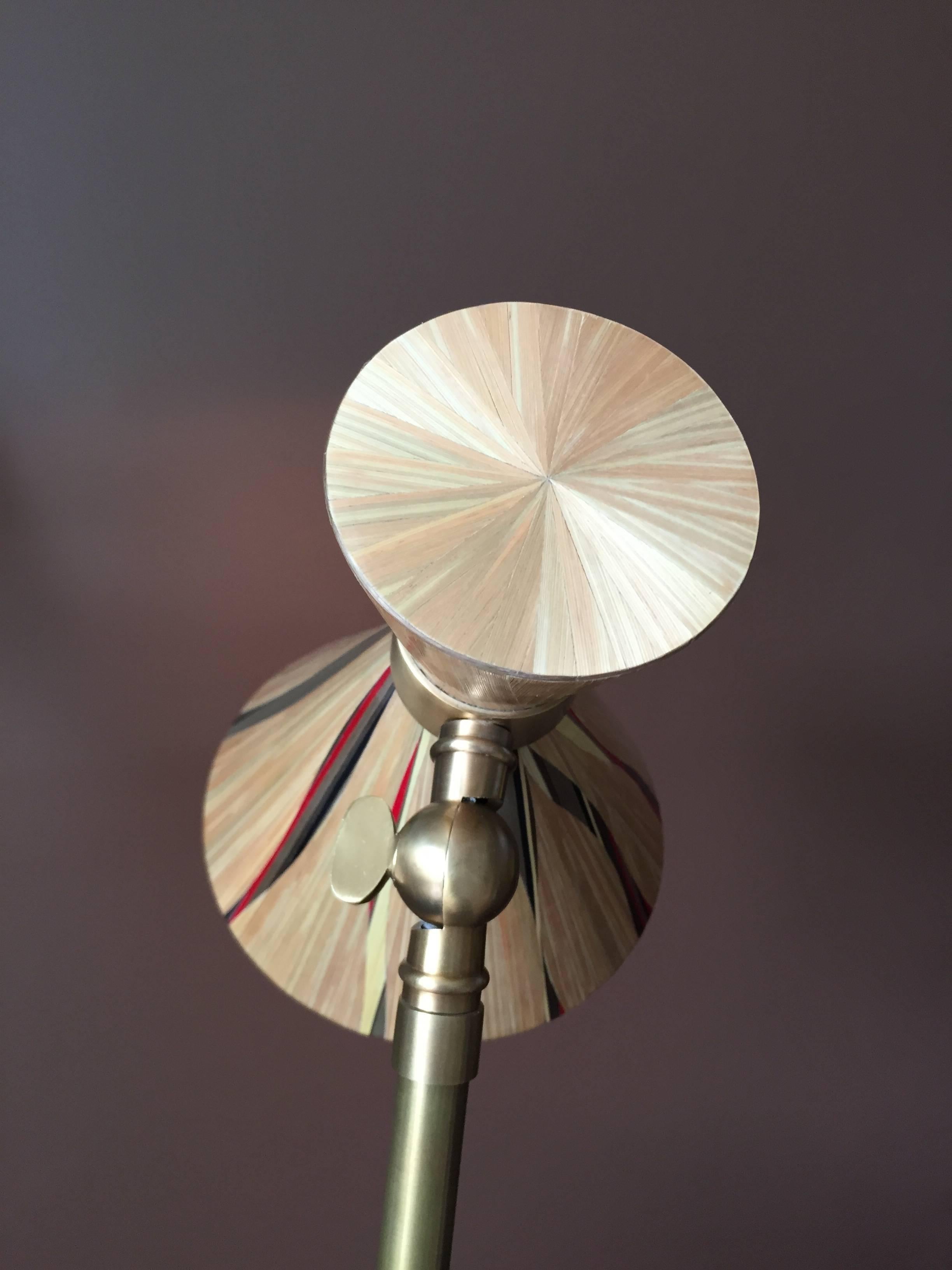 Gold straw marquetry table lamp with some colourful inserts in a brass base. Natural, red and bronze straw.


Straw and marquetry – matter and technique:

As early as the 17th century straw marquetry is used in furniture, bimbeloterie, the