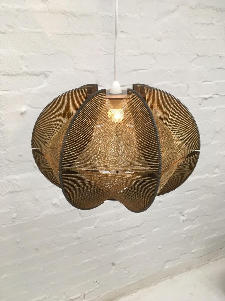 A fine, large Paul Secon geometric pendant light, produced by Sompex.

A smoke Lucite frame and rough textured gold string make this a particularly striking example. 

In excellent clean condition. Fits straight onto the end of a standard