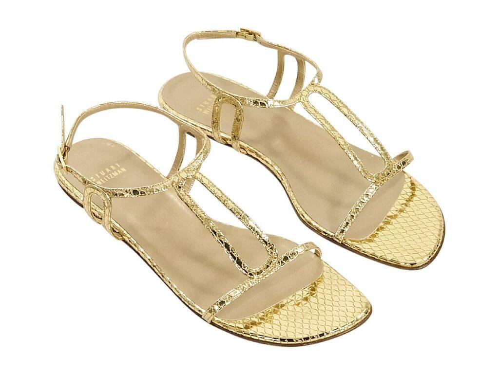 Product details:  Gold snake-embossed leather sandals by Stuart Weitzman.  Adjustable ankle strap.  Open toe.  Low stacked heel.  Goldtone hardware.  0.5