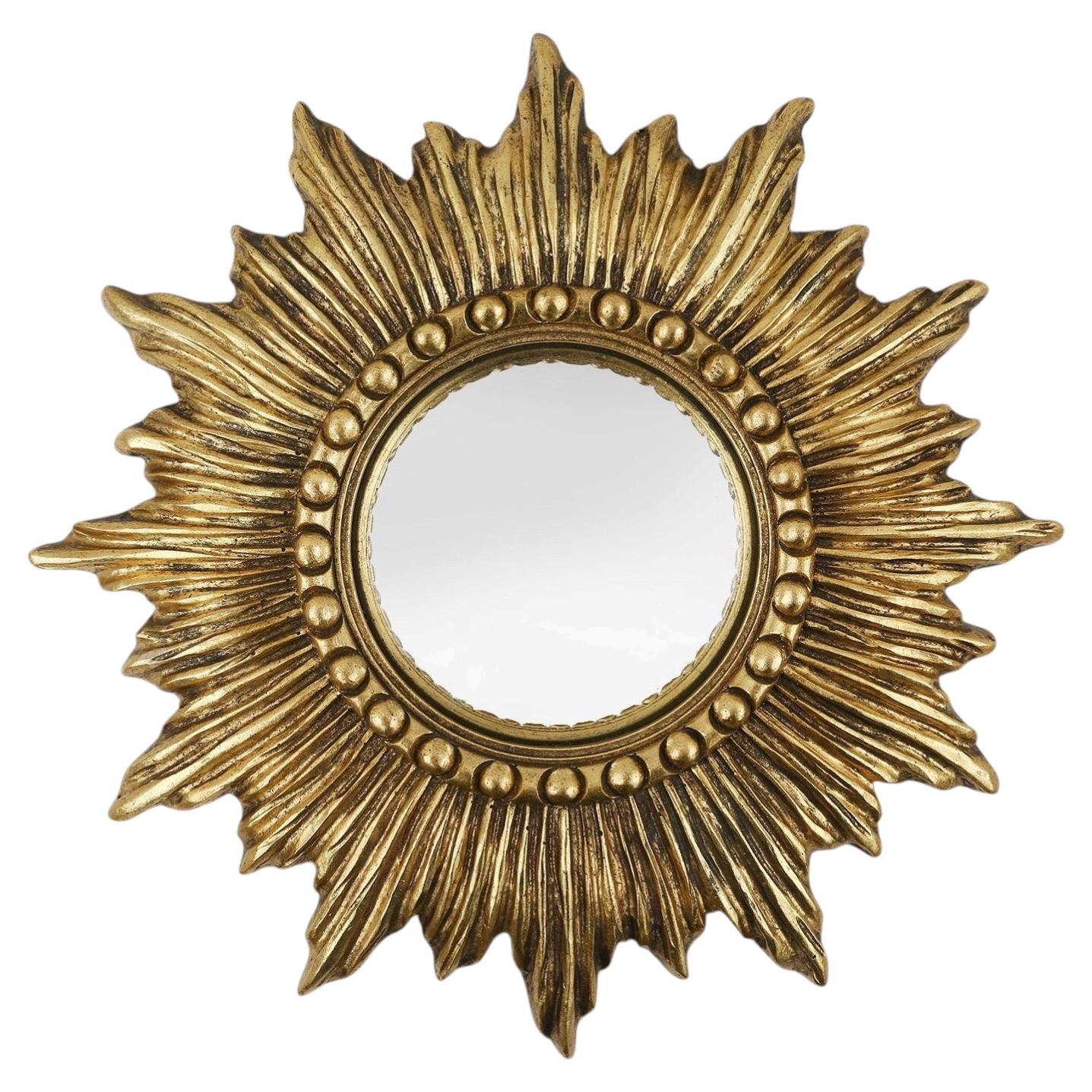 Gold sunburst mirror in resin with convex mirror, France ca. 1960