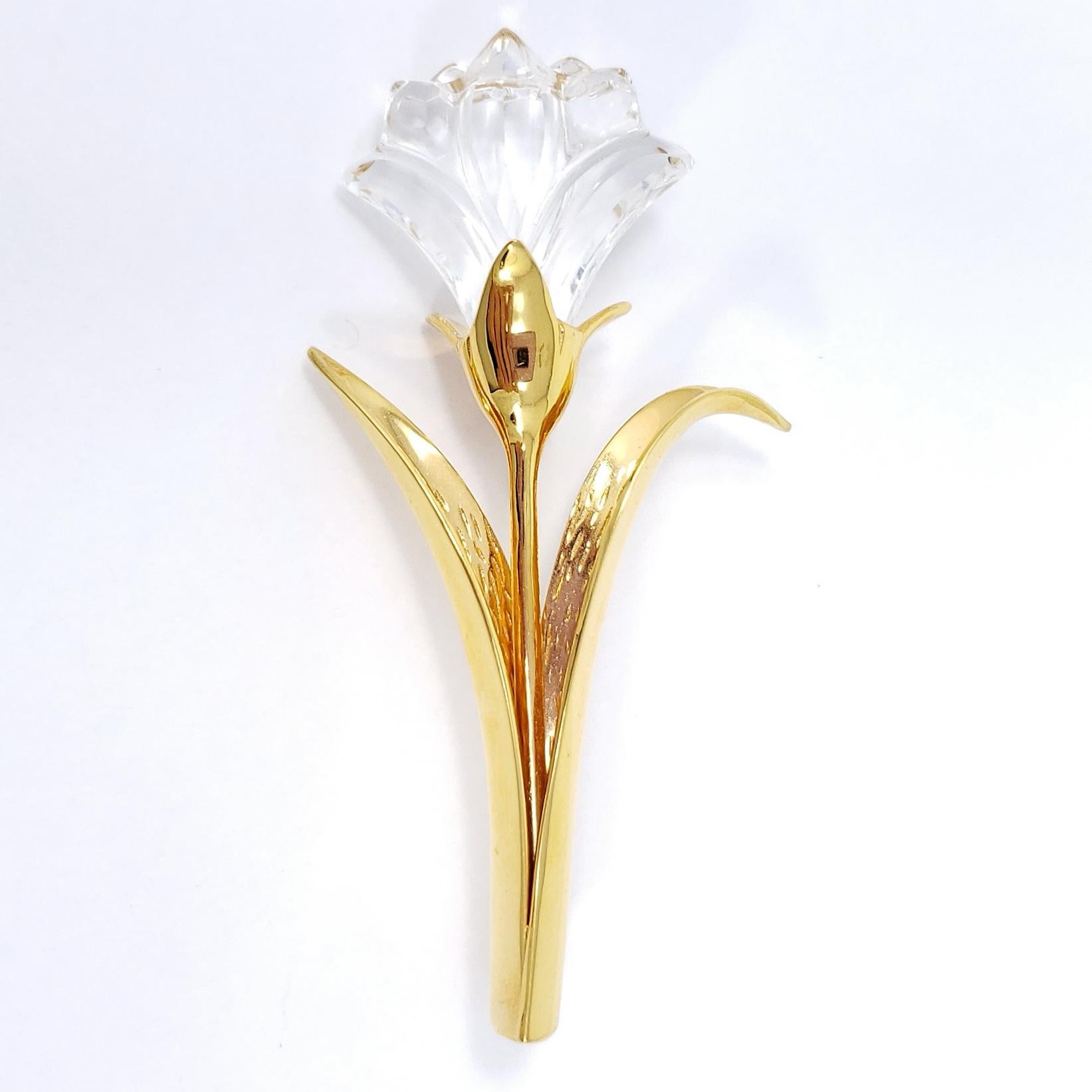A stylish lily pin brooch by Swarovski, featuring a gold-plated stem and crystal flower petals.

Hallmarks: Swarovski Swan