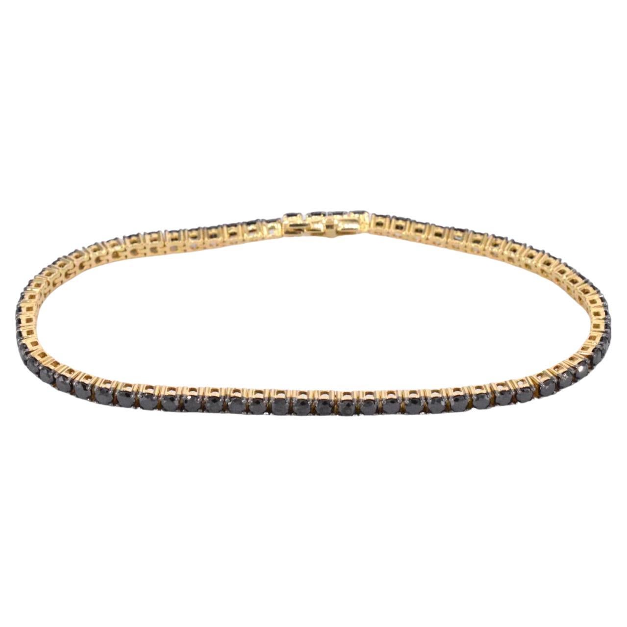 Gold tennis bracelet set with black diamonds