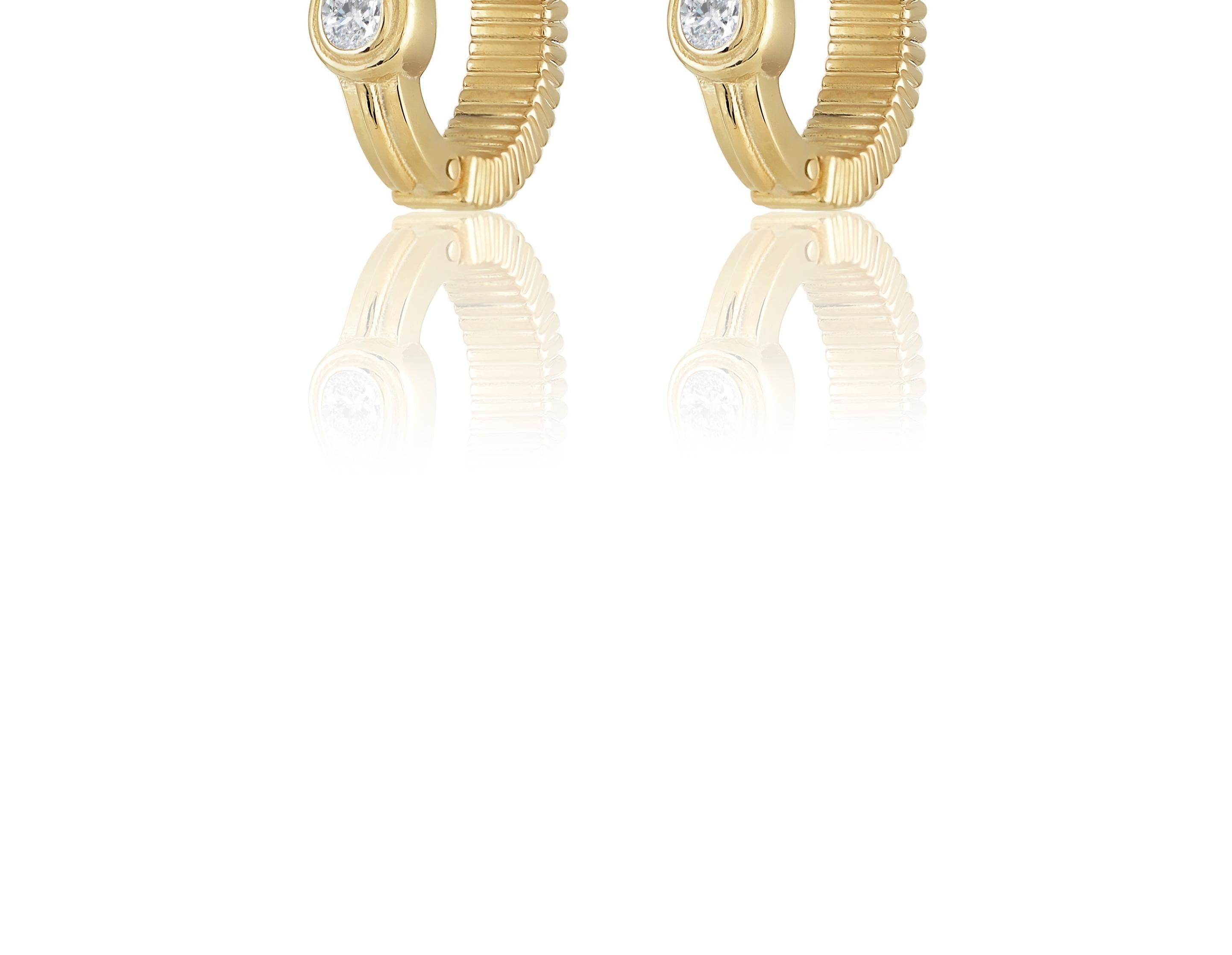 Designer: Alexia Gryllaki

Dimensions: motif L16x6mm
Weight: approximately 9.5g (pair)
Barcode: NEX4013


Gold Textures hoops in 18 karat yellow gold with pear-shape colorless diamonds approx. 0.50cts, that can be worn in two different ways, with