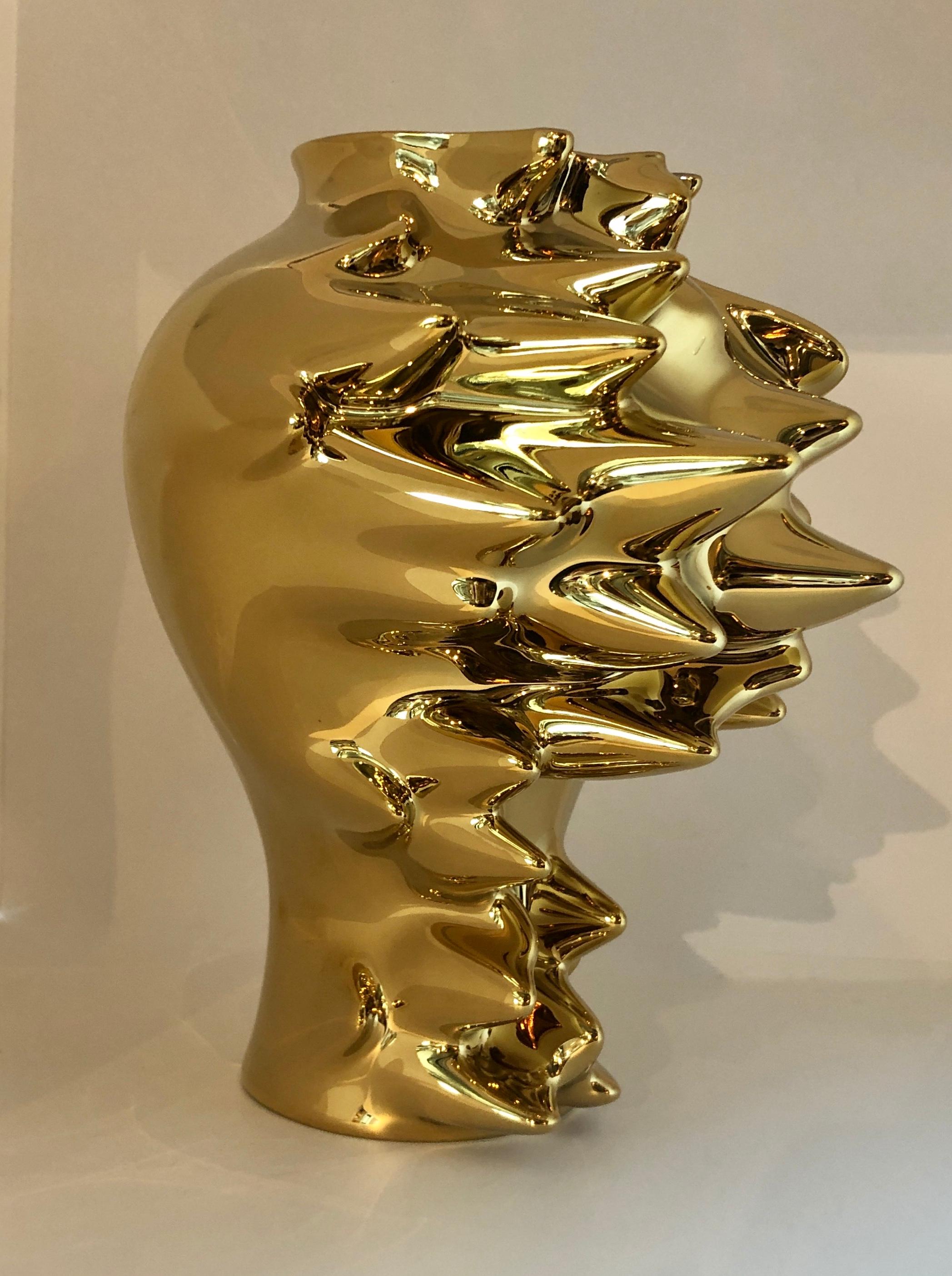 Offered is a gold titanium alloy over porcelain with white porcelain interior entitled 