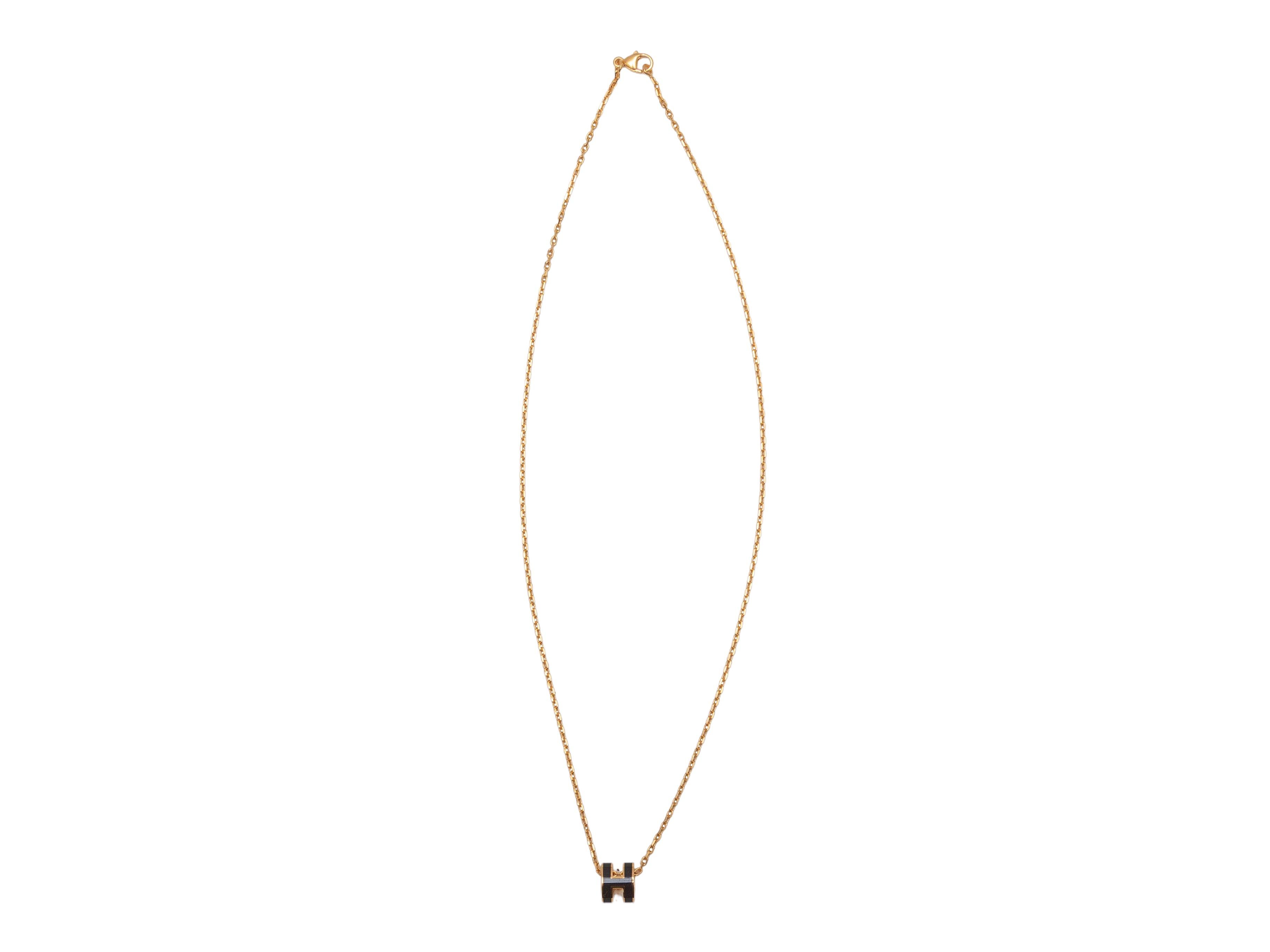 Gold-tone metal and black lacquer Mini Pop H necklace by Hermes. Lobster claw clasp closure. 0.27