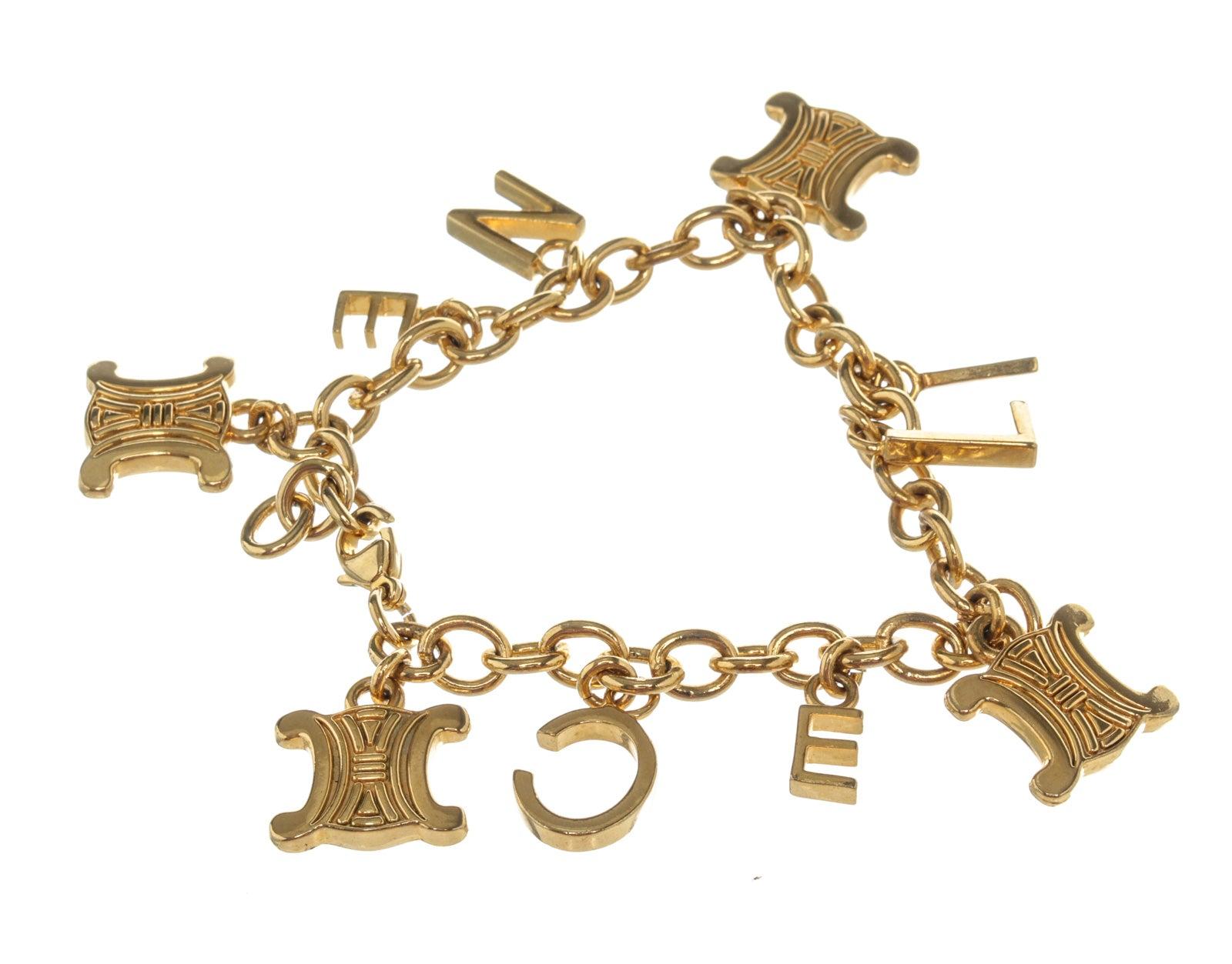 Gold-tone Celine bracelet with multi-charm Celine letters, Macadam logo, gold-tone hardware and lobster claw closure.
 

54398MSC