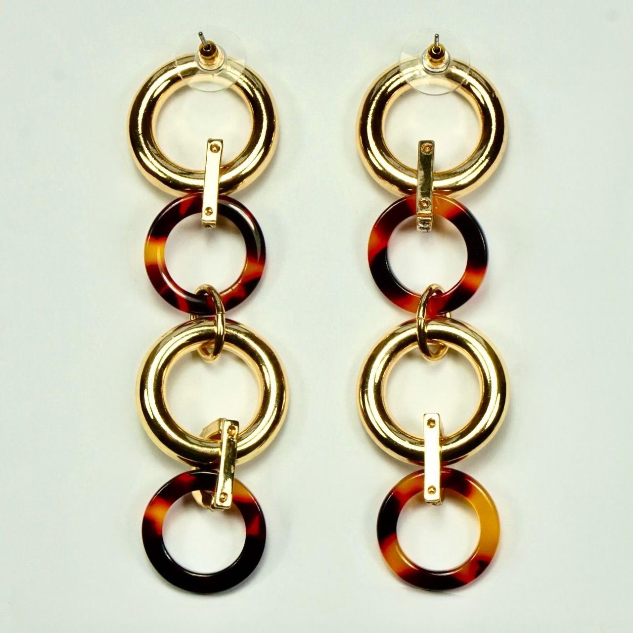 Stylish drop earrings, featuring contrasting faux tortoiseshell and gold tone hoops, joined with rhinestones. Measuring length 9.2 cm / 3.6 inches. 

This is a pair of modern drop earrings. They are glamorous earrings, wonderful for evening or
