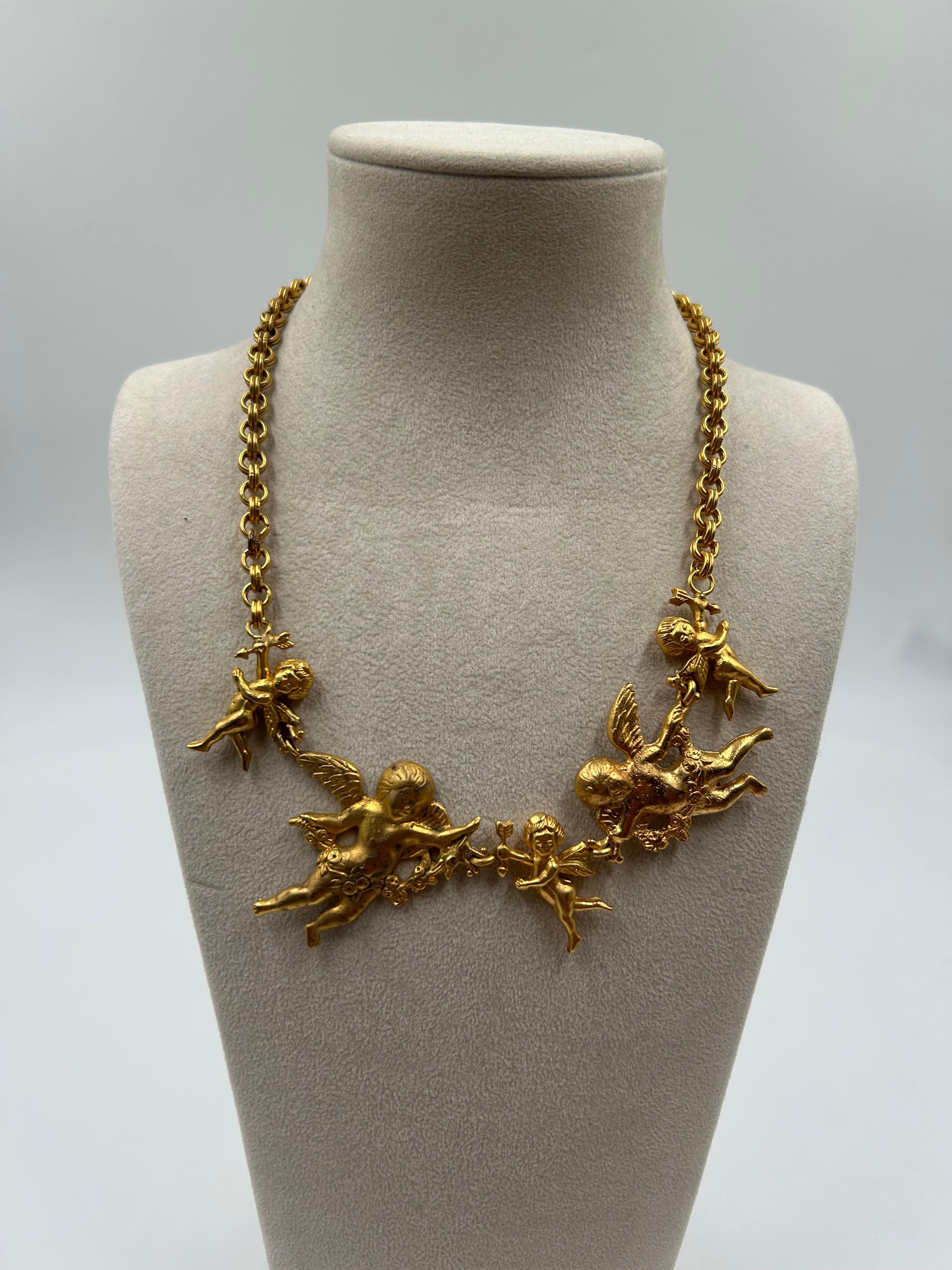 Heavenly and bold, this gold-toned brass statement necklace features some beautifully detailed angels motif, showcasing intricate craftsmanship and vintage design. The warm brass finish enhances the sculptural elegance of the piece, making it a