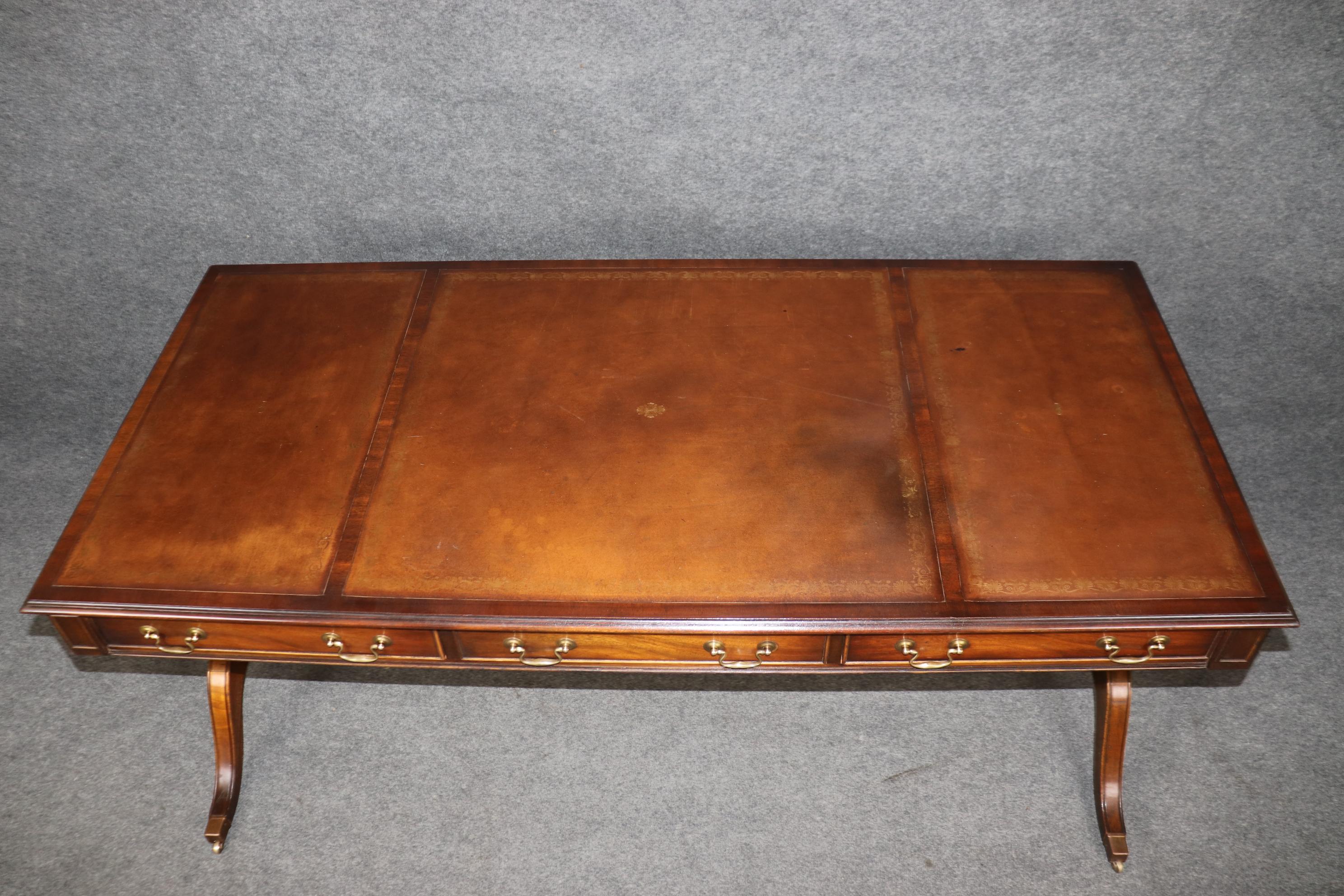 This is a fantastic, faithfully reproduced antique style Regency desk made by Reprodux of England. They made and still make some of teh most beautiful furniture in the world. They repruce fine English antiques and do it well. This desk is made of