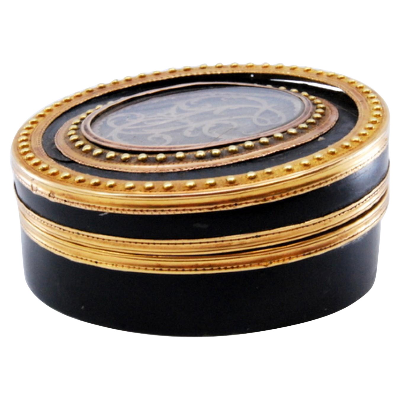 Gold tortoiseshell toiletry box with monogram on the removable lid