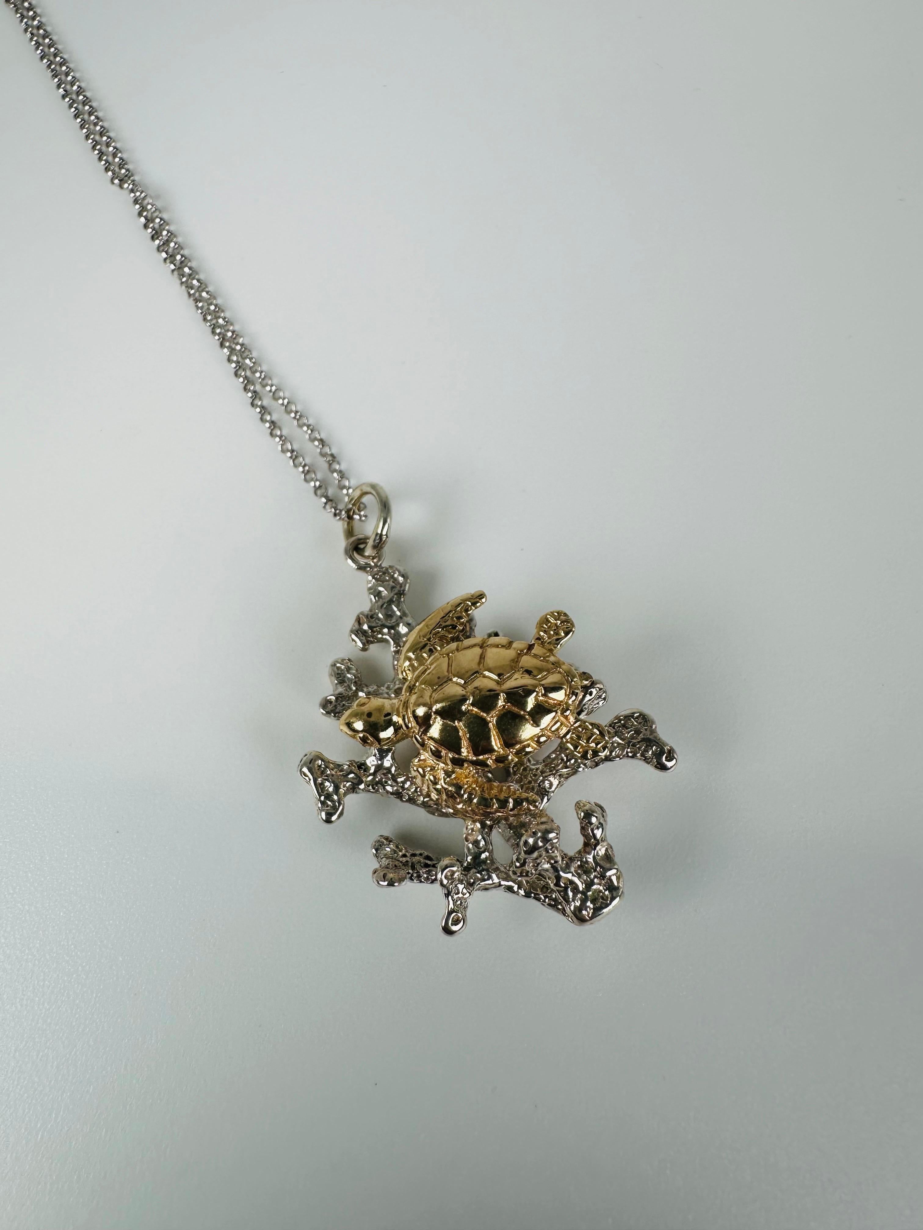 Lovely turtle pendant, the turtle is made from 100% gold 14KT the corals she is sitting on are made out of silver 925. The piece is very artistic, the chain is 18
