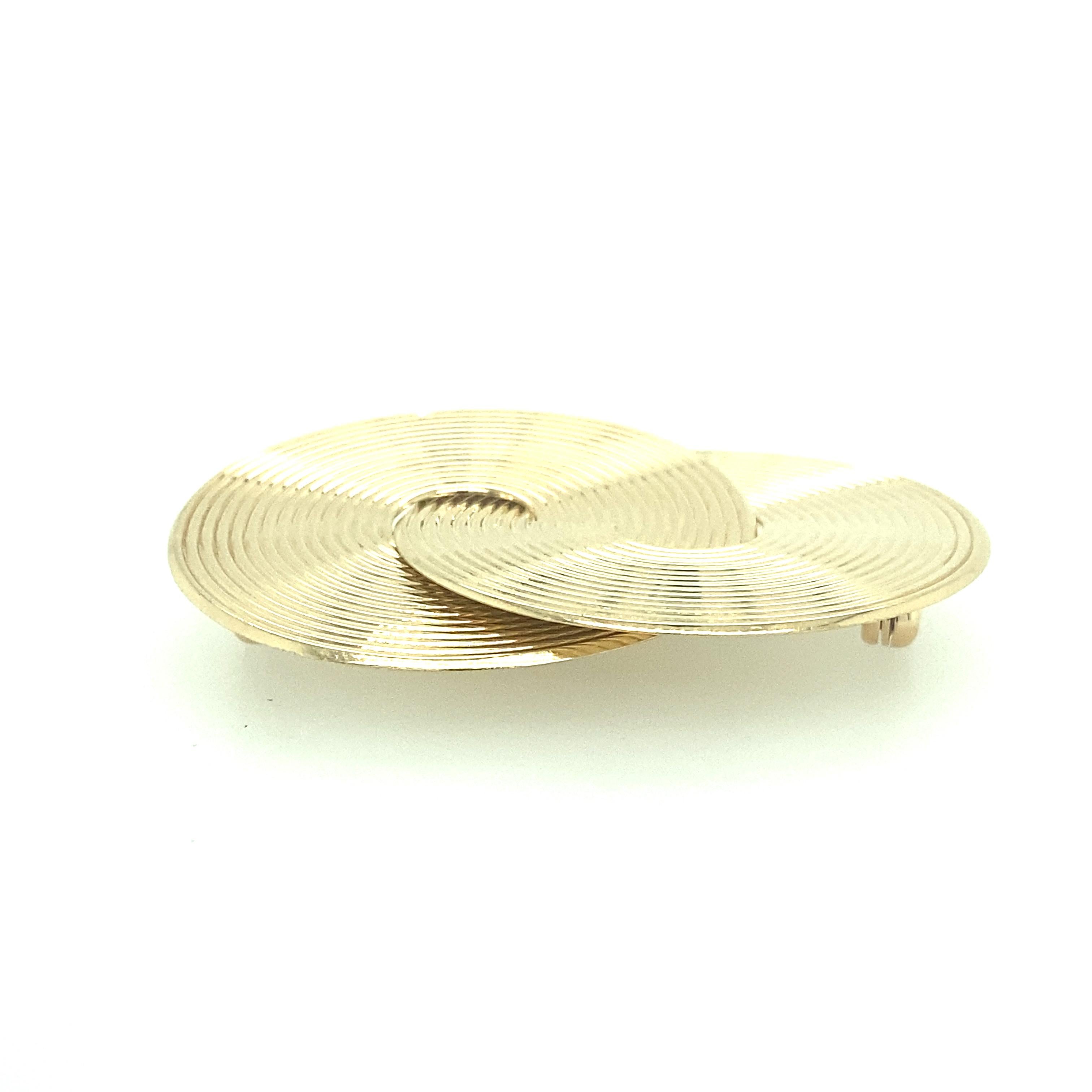 One 14 karat yellow gold estate twin circle pin measuring 1.5 x 1.75 inches and is complete with a double pin closure.