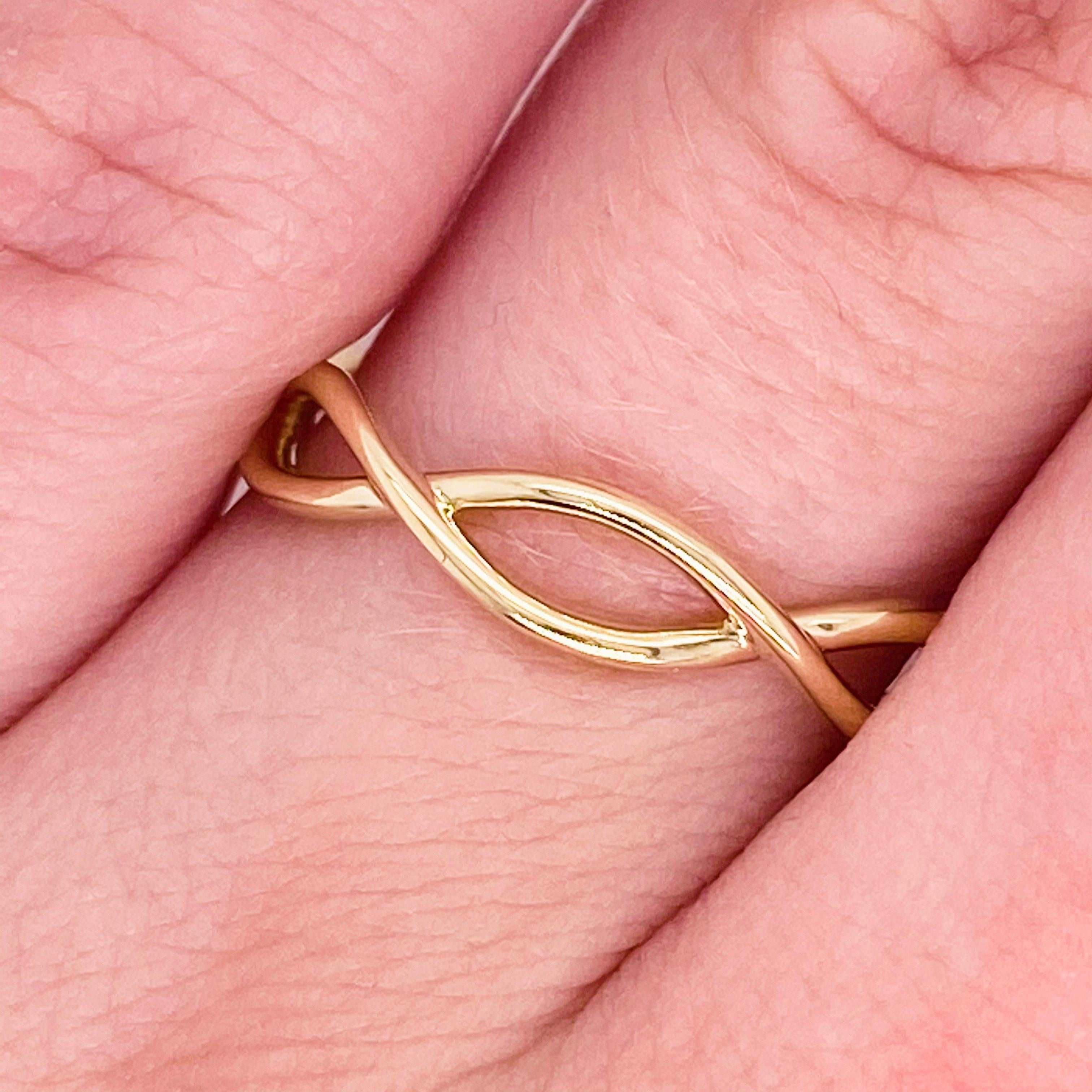 This lovely band has a beautiful twisted design! Accented by the lovely 14 karat yellow gold, this ring is an amazing fashion band and stackable band!  This pairs well with most engagement rings and wedding bands as well!  Treat yourself or your
