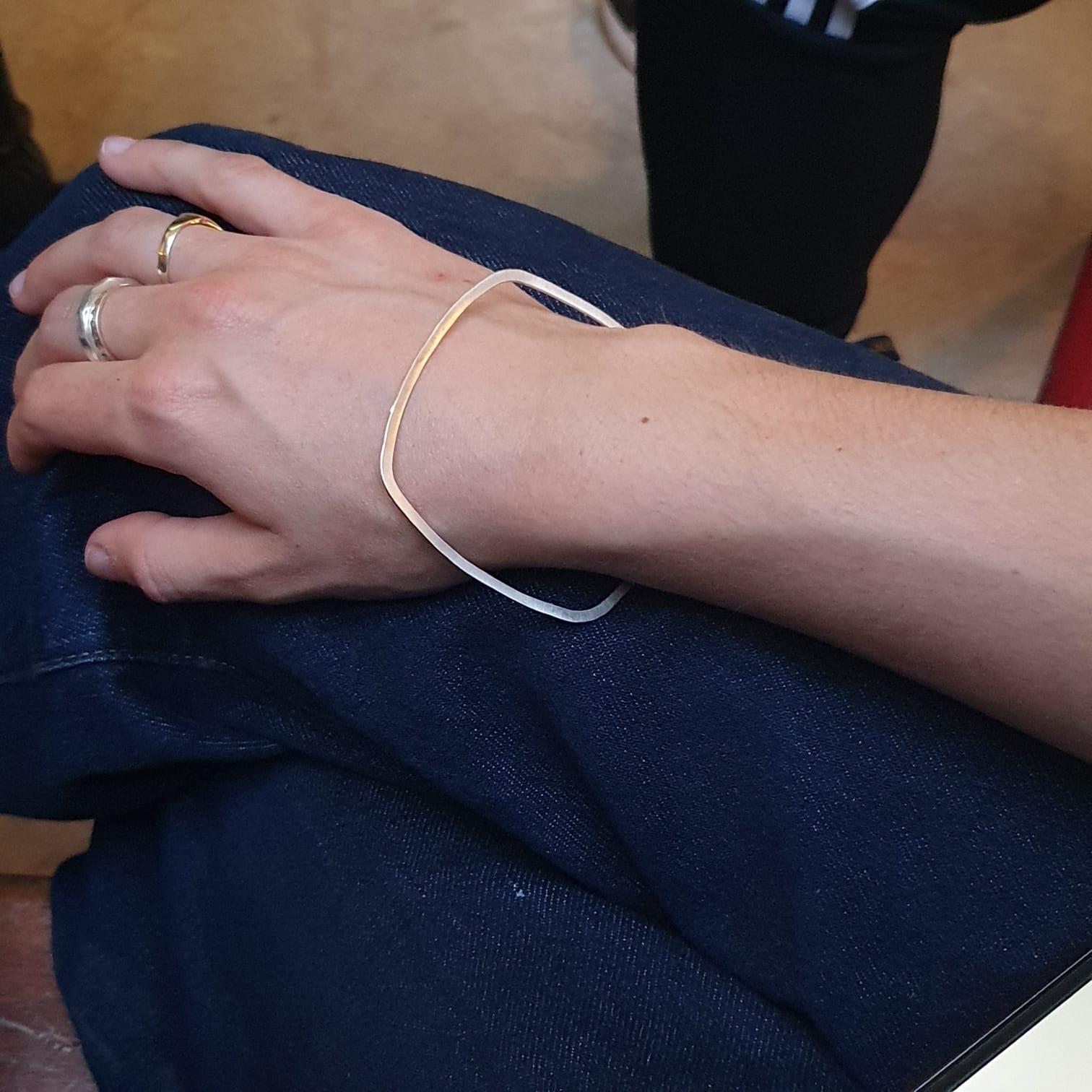 This delicate bangle is perfect for everyday and to wear alone or as a stacker. It is made from gold plated recycled sterling silver and is finished in a matte sheen with shiny burnished edges to subtly catch the light when worn.

It is hallmarked