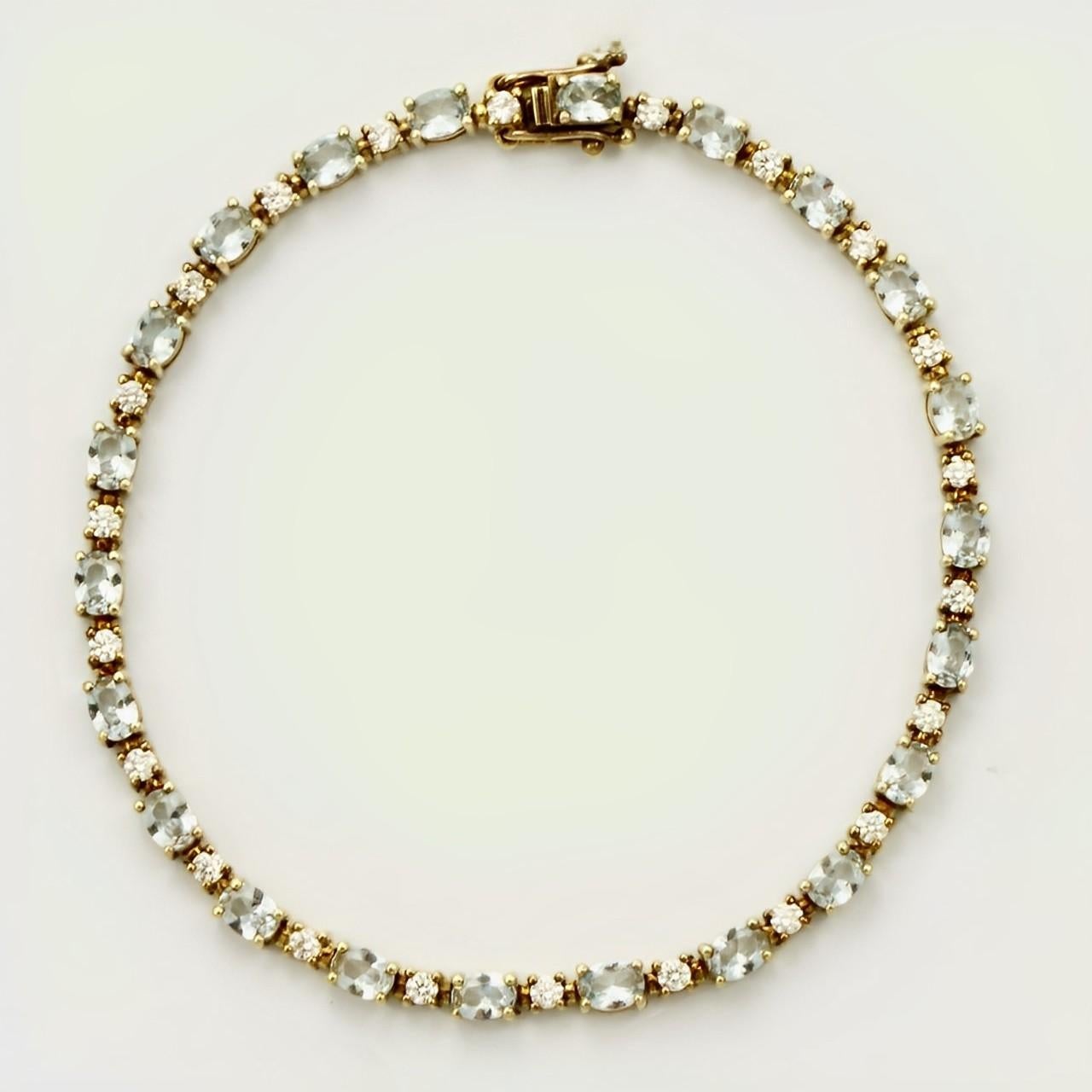 Beautiful gold vermeil on sterling silver tennis bracelet with a double safety catch, set with oval pale blue and round clear faceted cubic zirconias in open back settings. Measuring length 17.6 cm / 6.9 inches by width 3 mm / .11 inch, and depth