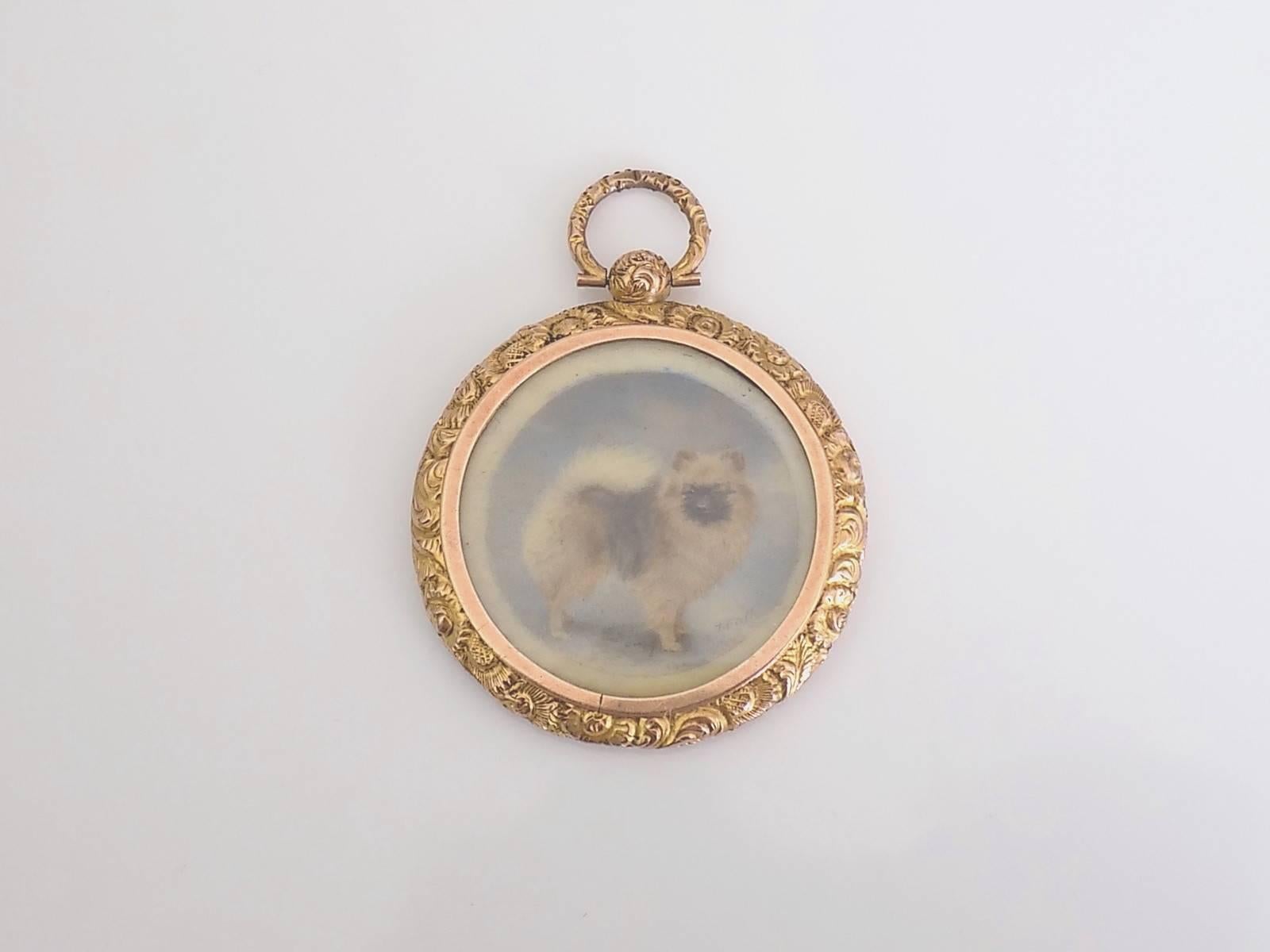 An Extremely rare a late Victorian hand painted miniature of Pomeranian dog in chased 9 Carat Gold glazed locket pendant. The miniature signed by T. Fall. English origin.
Total Drop of the locket 50mm, Width 37mm.
Marked 9CT for 9 carat gold.
The