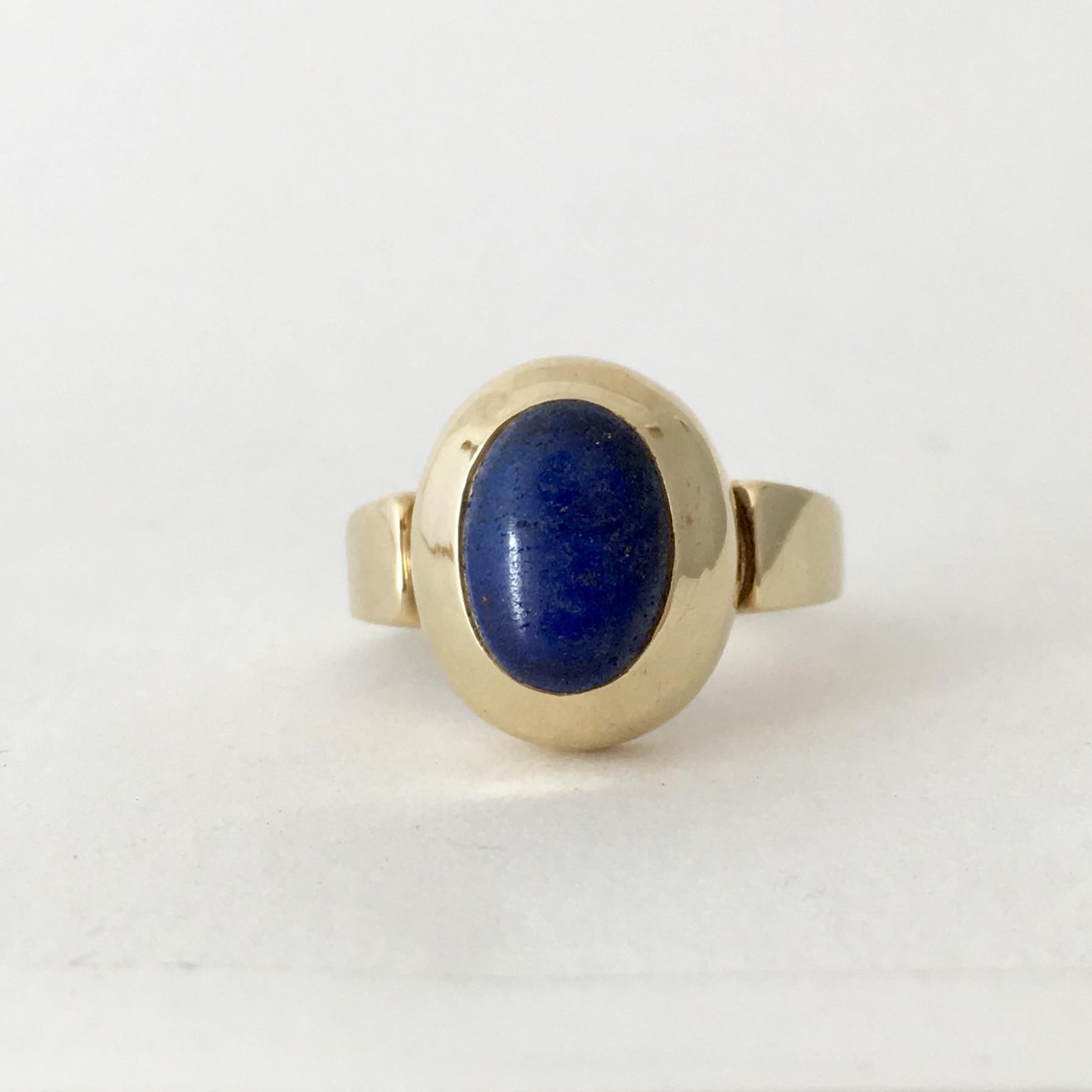 This stylish 9ct gold ring is a strikingly bold design. The cobalt blue of the lapis lazuli stone is offset perfectly by the warm yellow gold of the setting. The inside of the band is stamped '9ct' and also fully hallmarked for Sheffield, England,