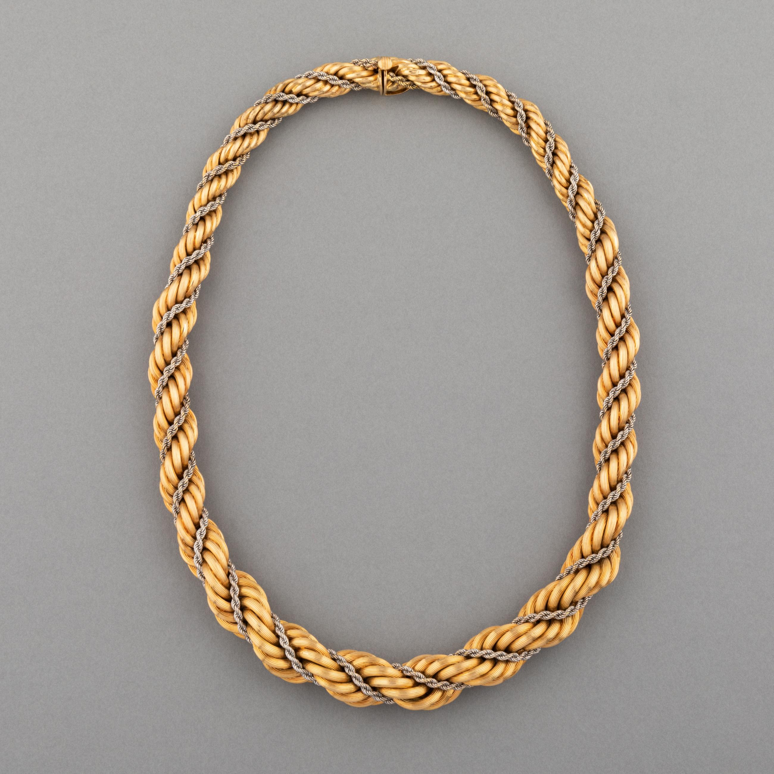 A very lovely vintage necklace, European made circa 1960.

Made in yellow and white gold 18K. Hallmarks for gold and maker (Unknown).

The weight is 85.4 grams. 

The length is 44.5 cm.

The width is from 9mm to 14mm.