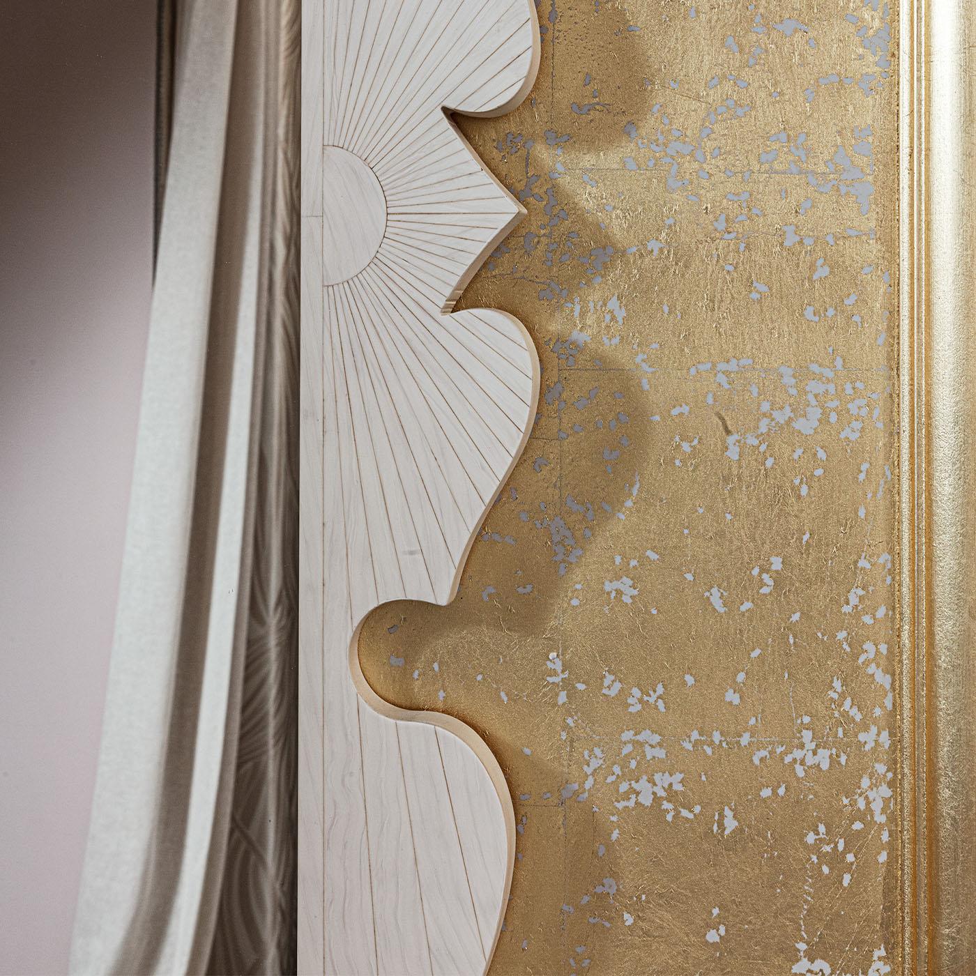 This handcrafted eco-ivory inlaid mirror is framed with exquisite gold leaf detailing.