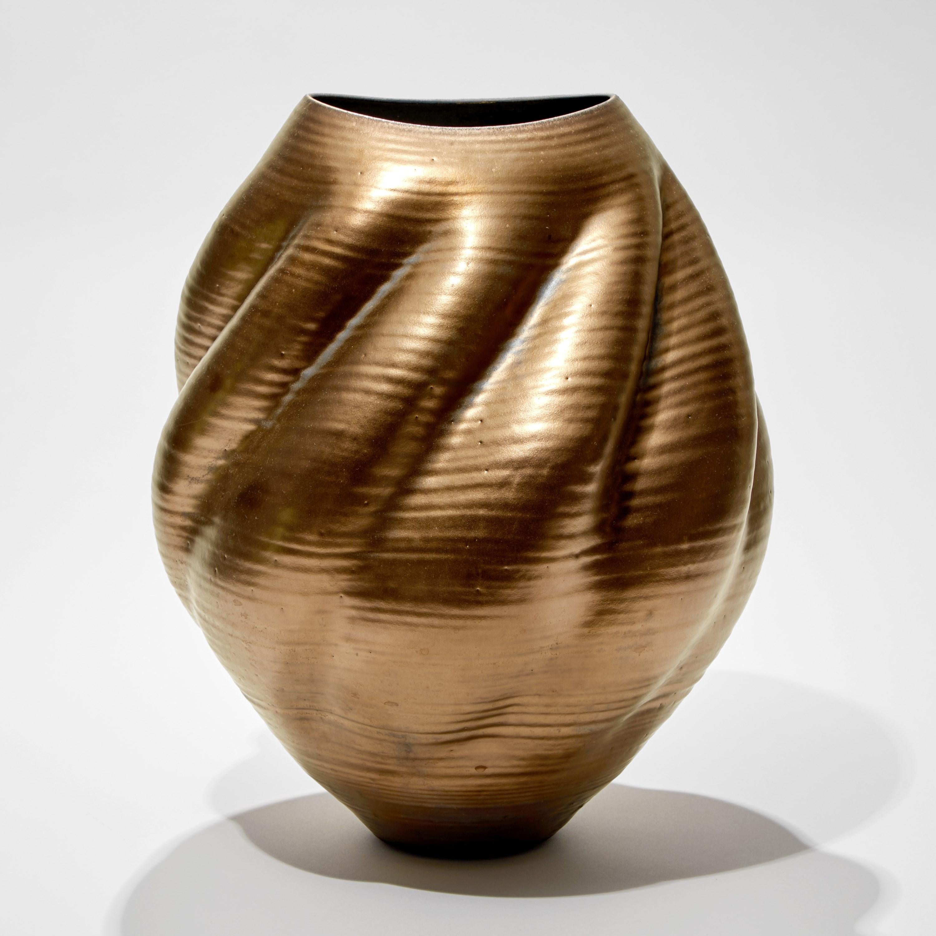 Gold Wave Form No 80 is a unique glazed ceramic sculptural vessel by the British artist, Nicholas Arroyave-Portela.

Nicholas Arroyave-Portela’s professional ceramic practice began in 1994. After 20 years based in London, he moved and set up his